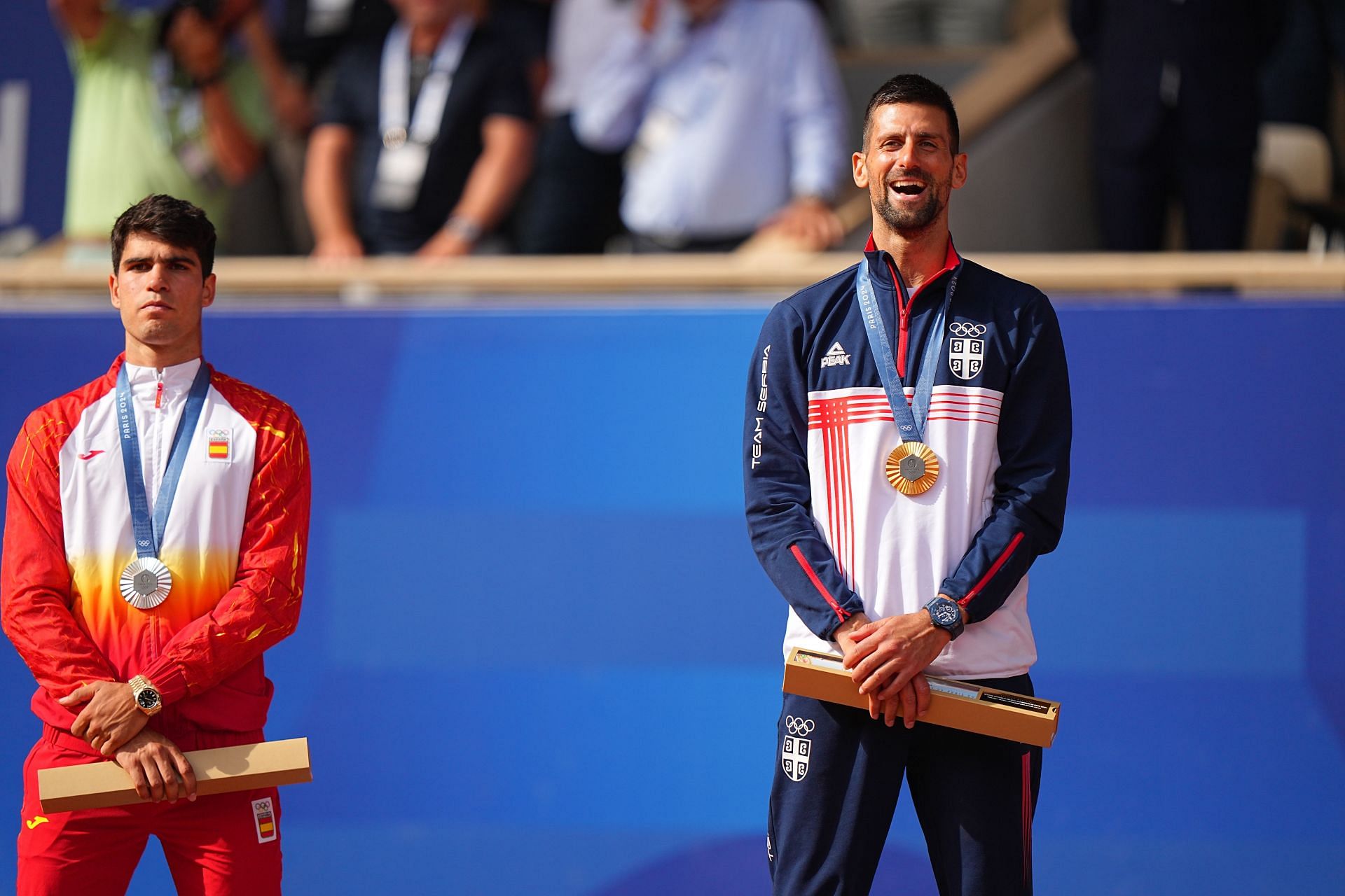 Carlos Alcaraz (L) and Novak Djokovic (R) on the podium at the 2024 Summer Olympics. (Image: Getty)