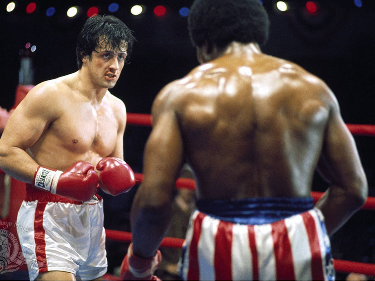 Rocky (Sylvester Stallone) facing Apollo Creed (Carl Weathers) in the movie (image via MGM)