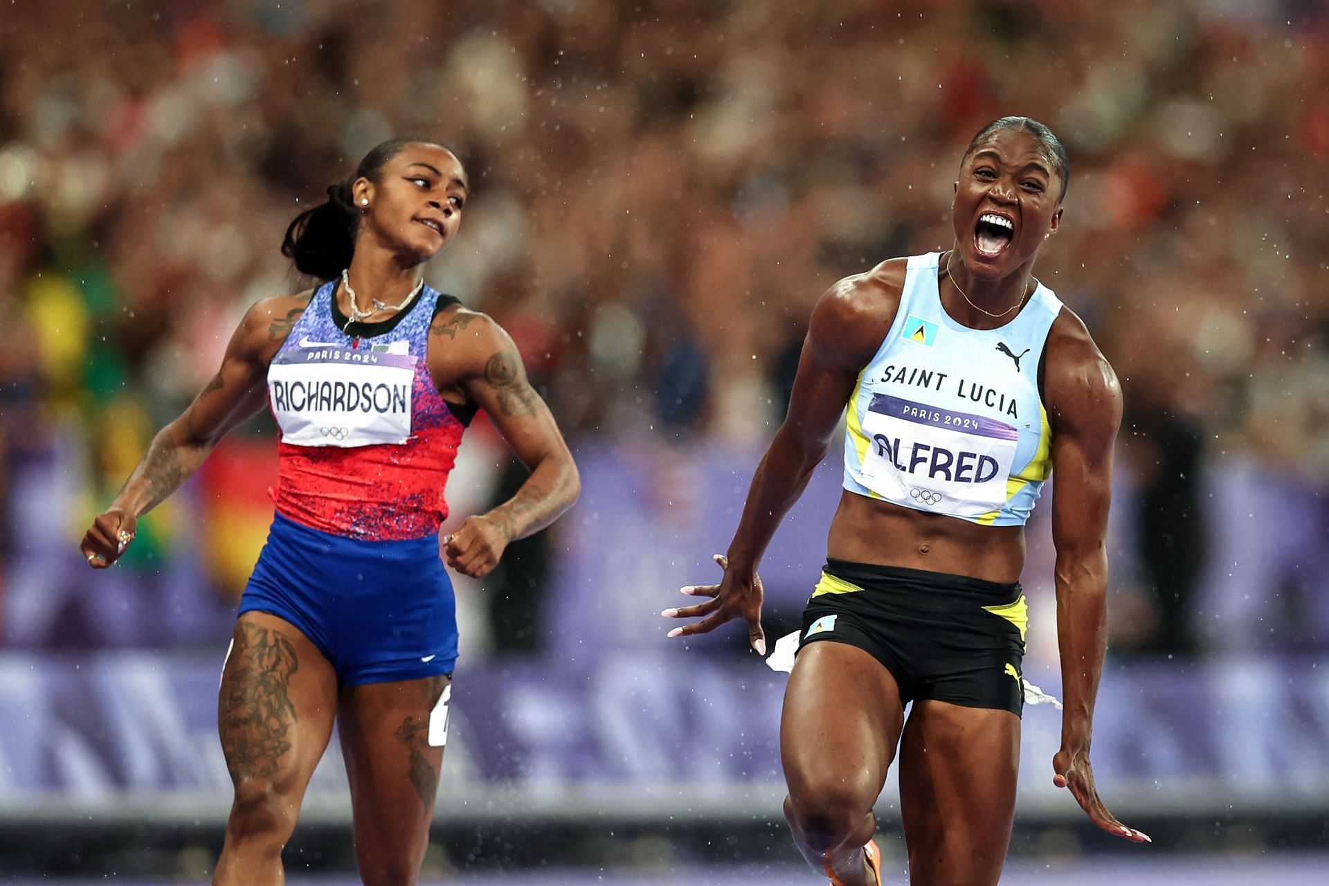 Sha&#039;Carri Richardson of USA looks on as Julien Alfred of Saint Lucia celebrates her win in 100m at Paris Olympics 2024 [Image Sources: Getty]