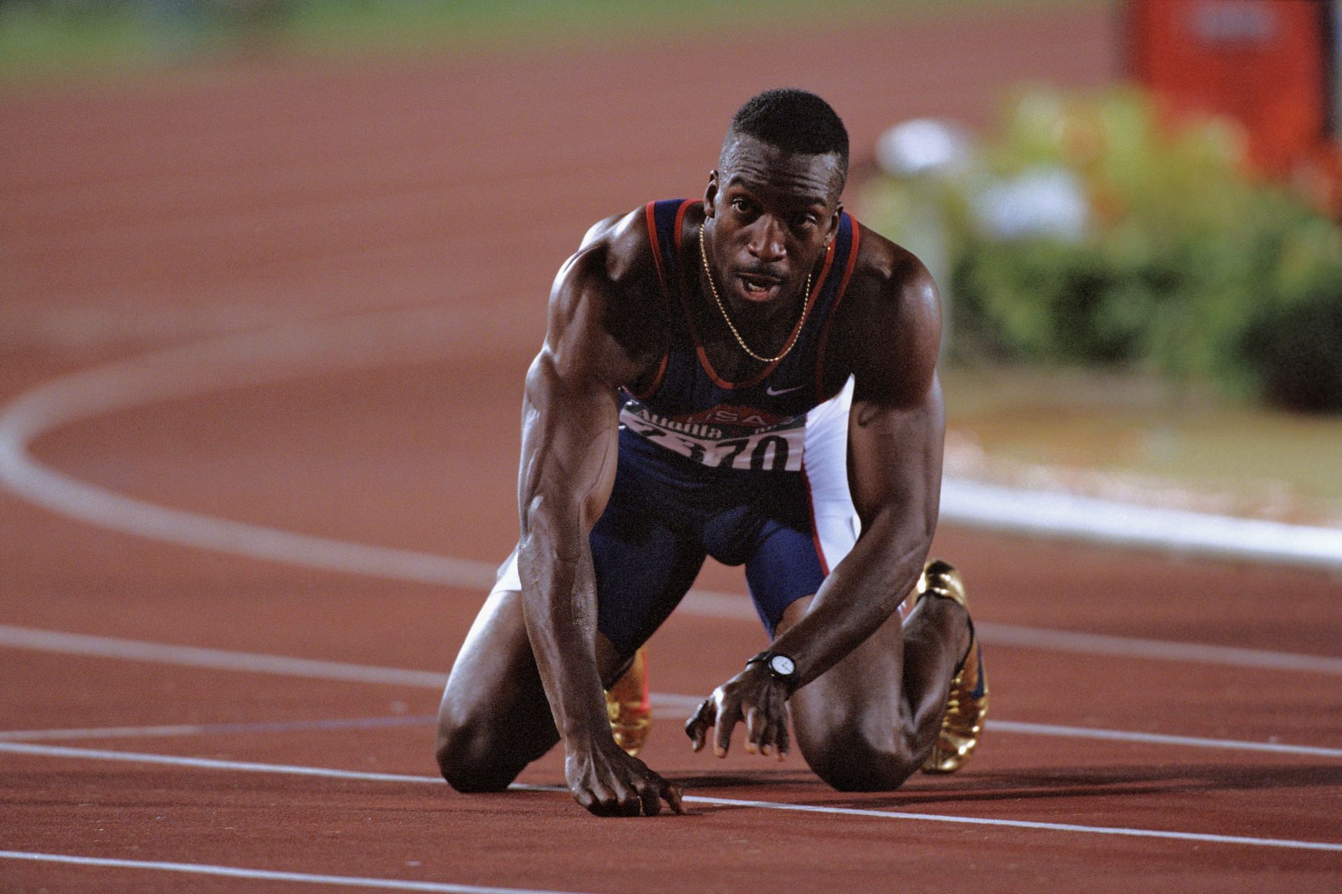 Michael Johnson reacts after winning the 200m event at the Atlanta Olympics in 1996 [Image Source: Getty]