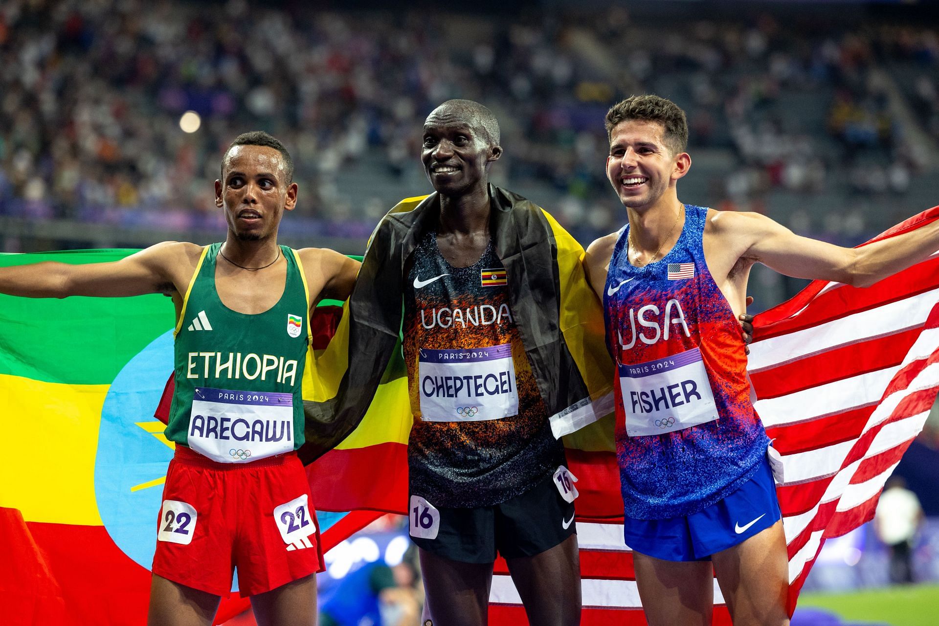 Grant Fisher [R ] with the other medalists from the Paris 2024 men&#039;s 10000m, Berihu Aregawai [L] of Ethiopia, and Joshua Cheptegei [C] of Uganda [Image Source: Getty]