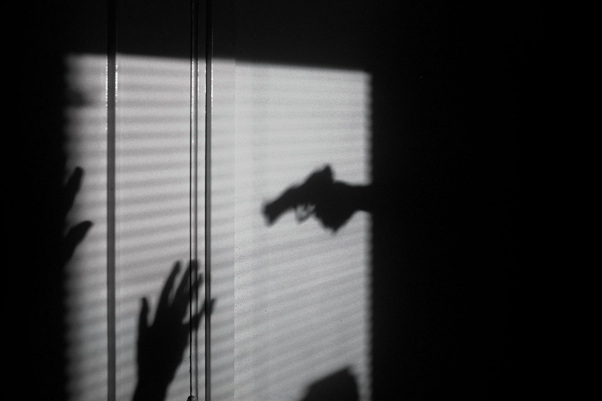 Shadow of a pistol (Image via Unsplash)