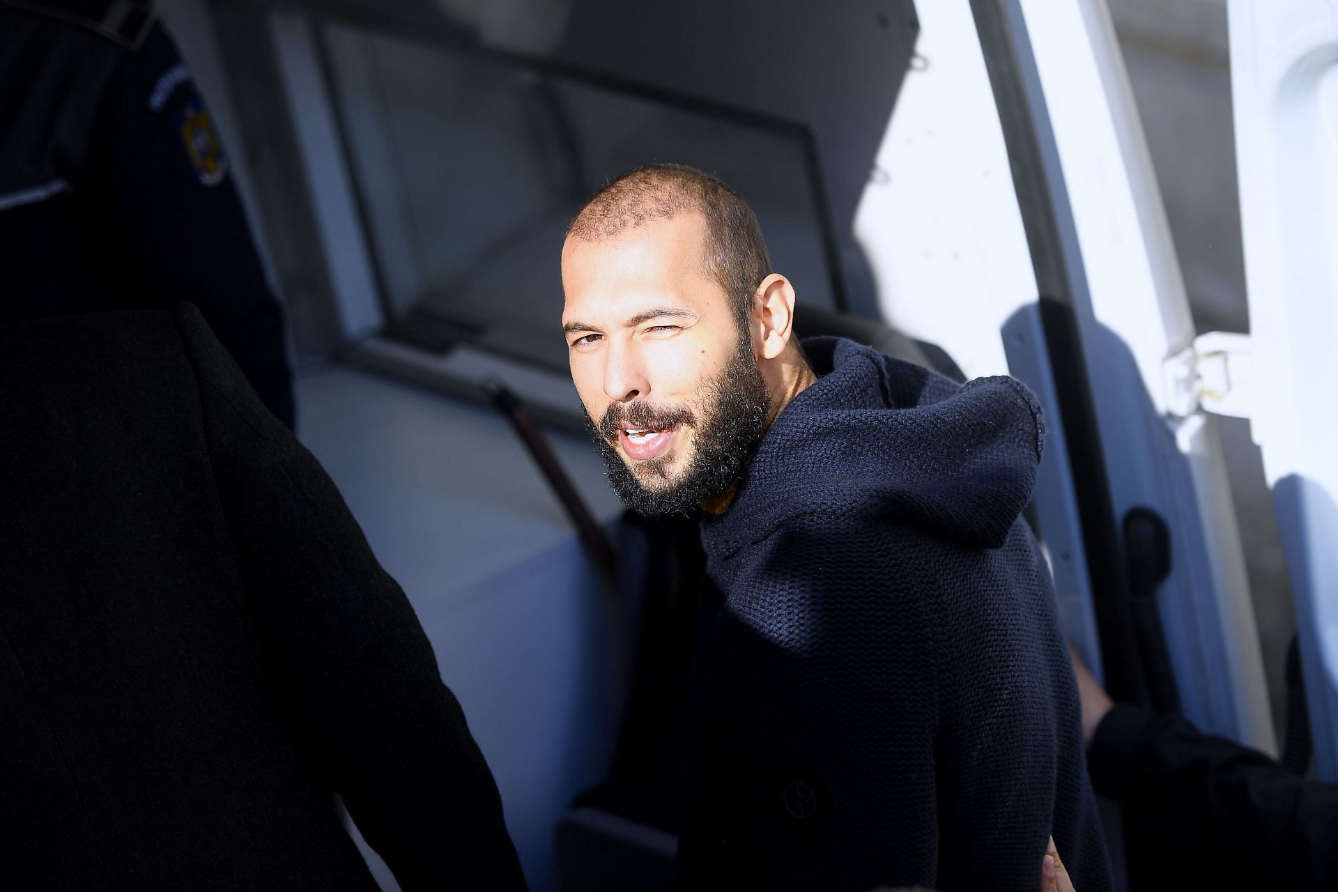 Andrew Tate leaves court after his trial in Romania - Source: Getty