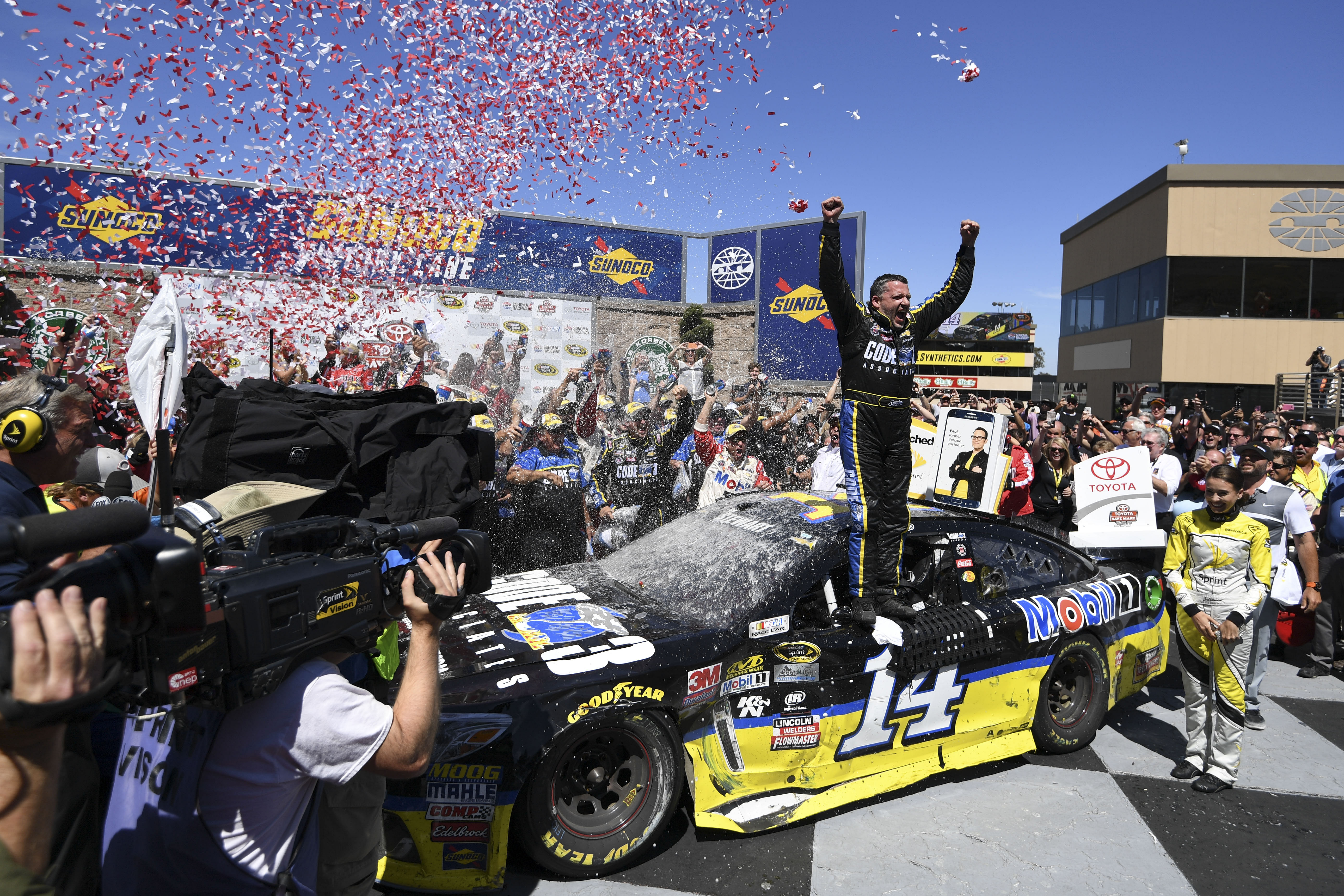 Tony Stewart (14) celebrates in victory lane during the Toyota Save Mart 350 at Sonoma Raceway. Mandatory Credit: Kyle Terada-USA TODAY Sports. Source: Imagn