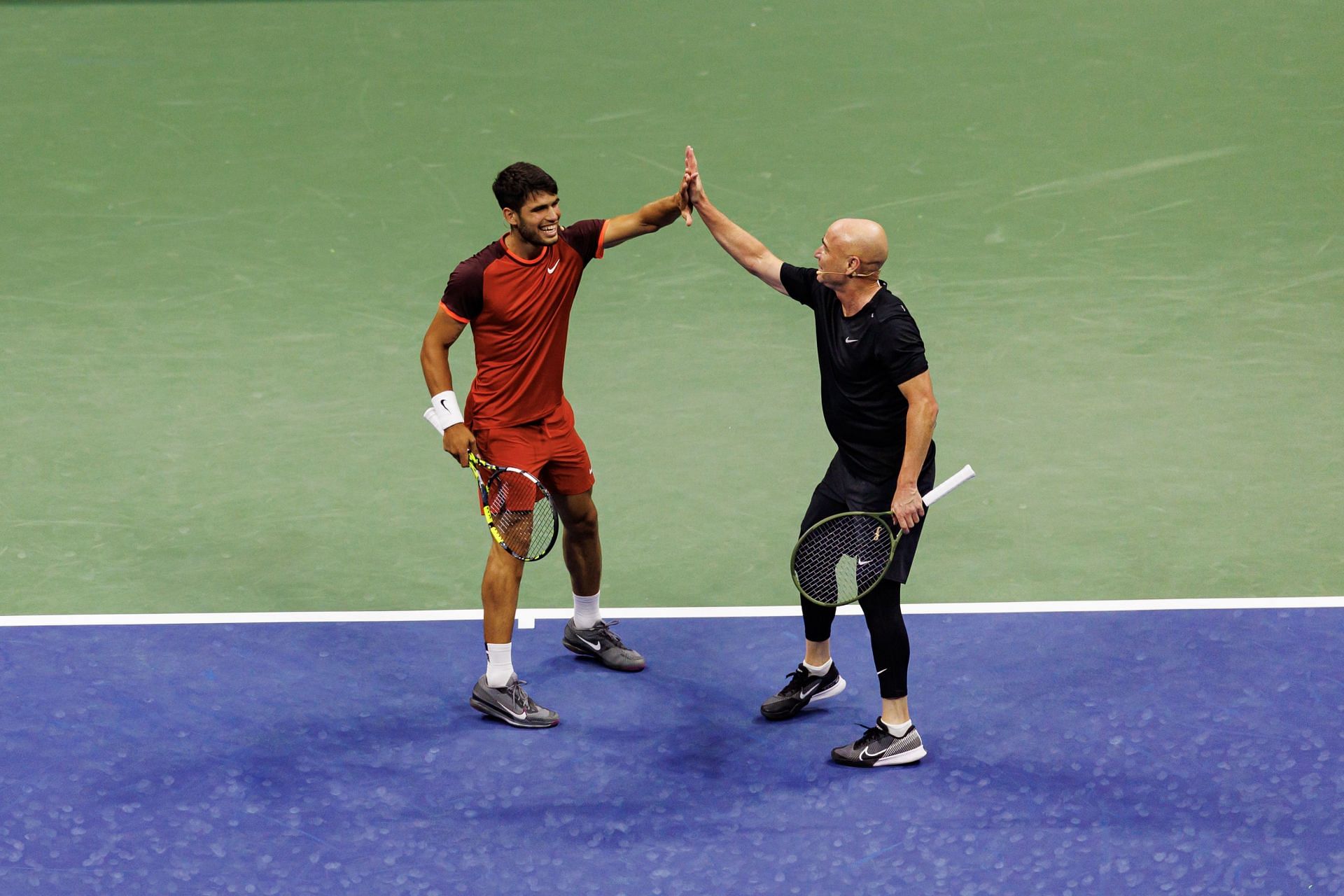 Carlos Alcaraz and Andre Agassi during an exhibition match ahead of the 2024 US Open (Image via Getty)