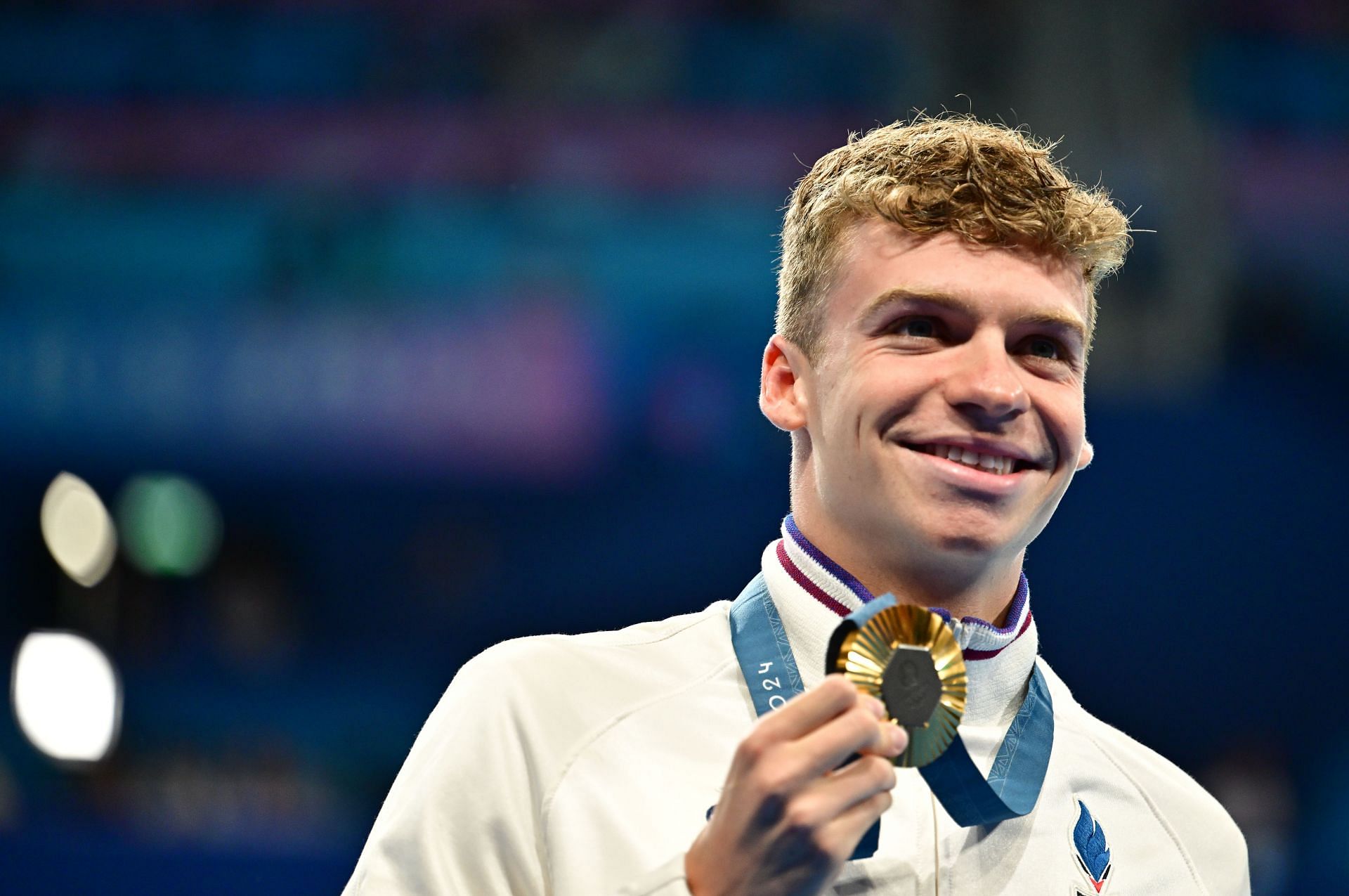 Leon Marchand with the gold medal from 200m Individual Medley event at the Paris Olympics [Image Sources: Getty]