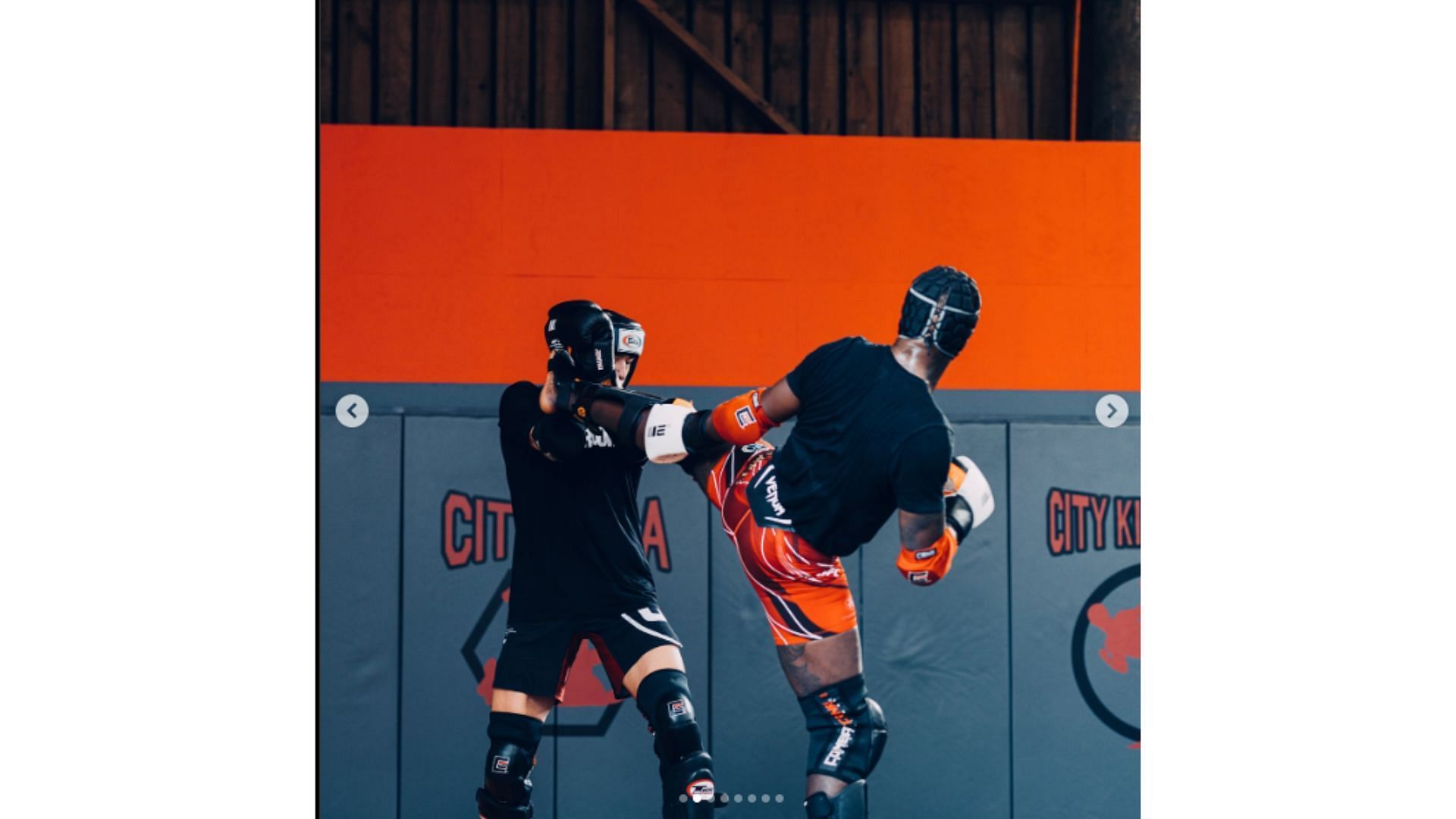 Israel Adesanya landing a head kick