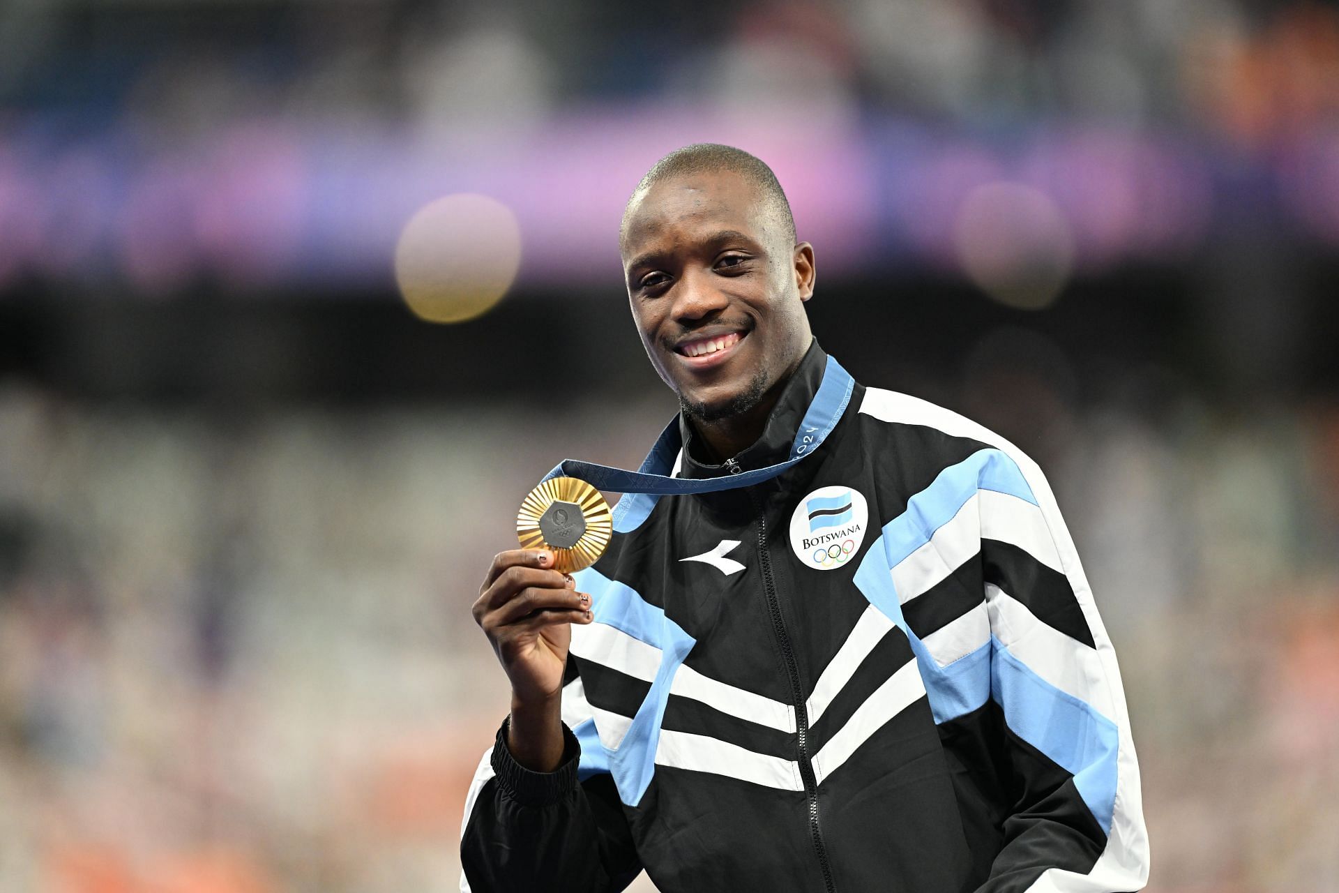 Letsile Tebogo of Botswana with the gold medal for the men&#039;s 200m at the Paris Olympics 2024 [Image Source: Getty]