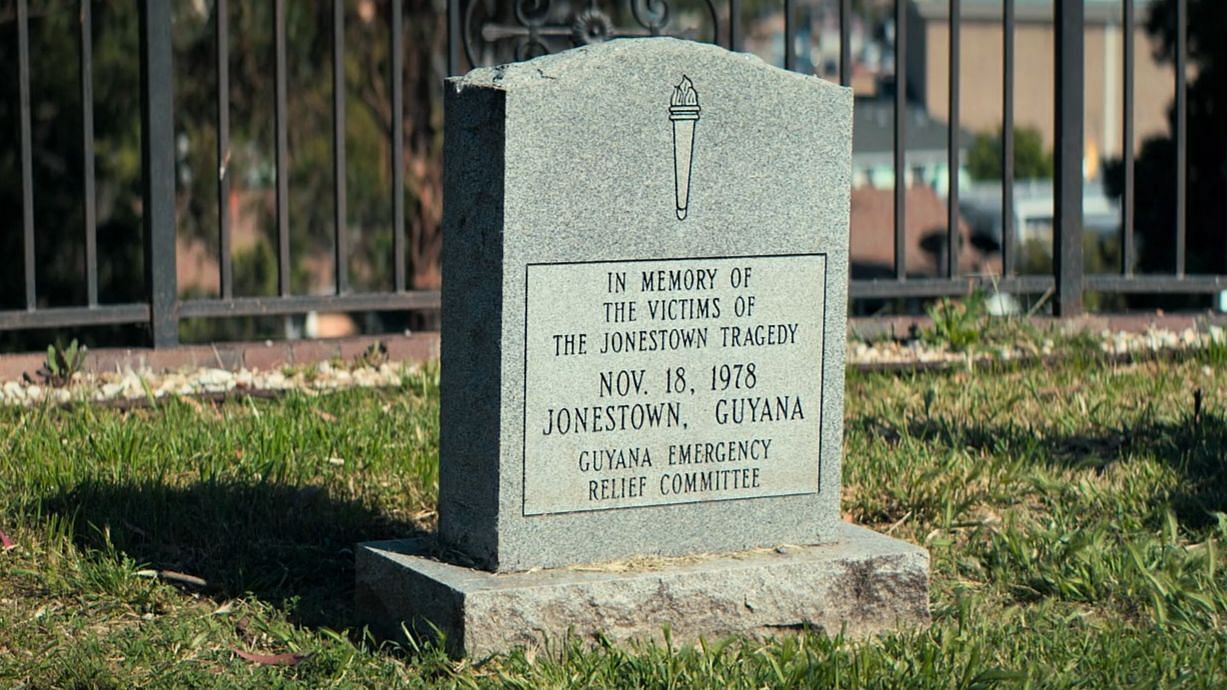 A still of the gravestone in Oakland from Cult Massacre: One Day in Jonestown 