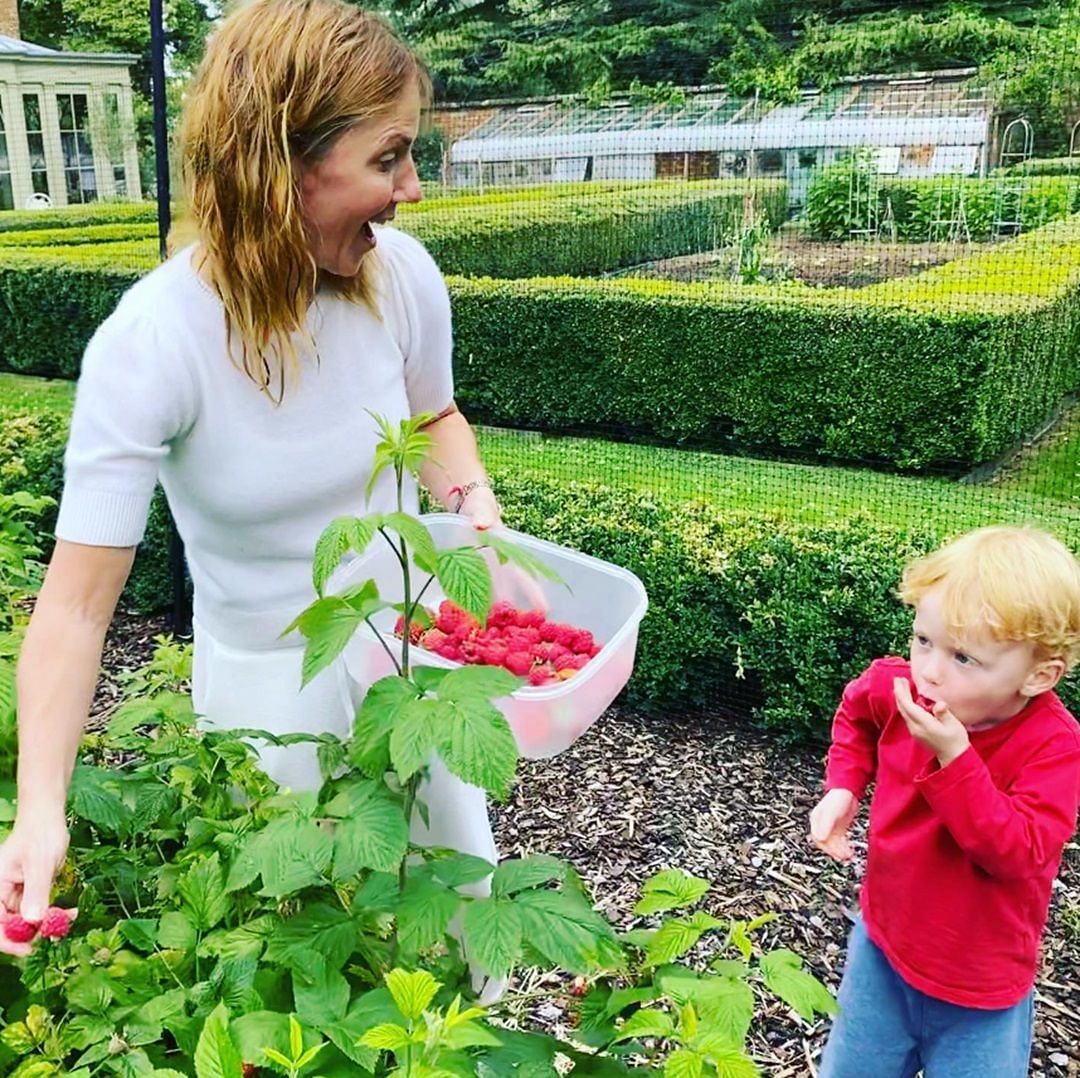 Spice Girl Geri Halliwell with her son Monty in their garden picking up raspberries (Source: @therealgerihalliwell on Instagram)