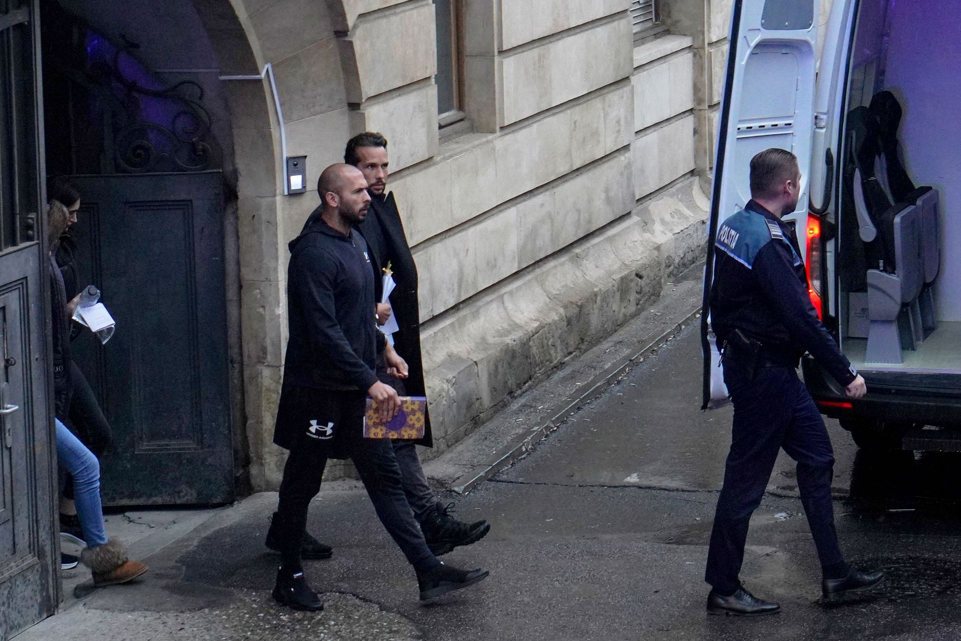 Andrew Tate (L) and Tristan Tate leave the Bucharest Court of Appeal on January 10, 2023, in Bucharest, Romania.  (Image via Getty)