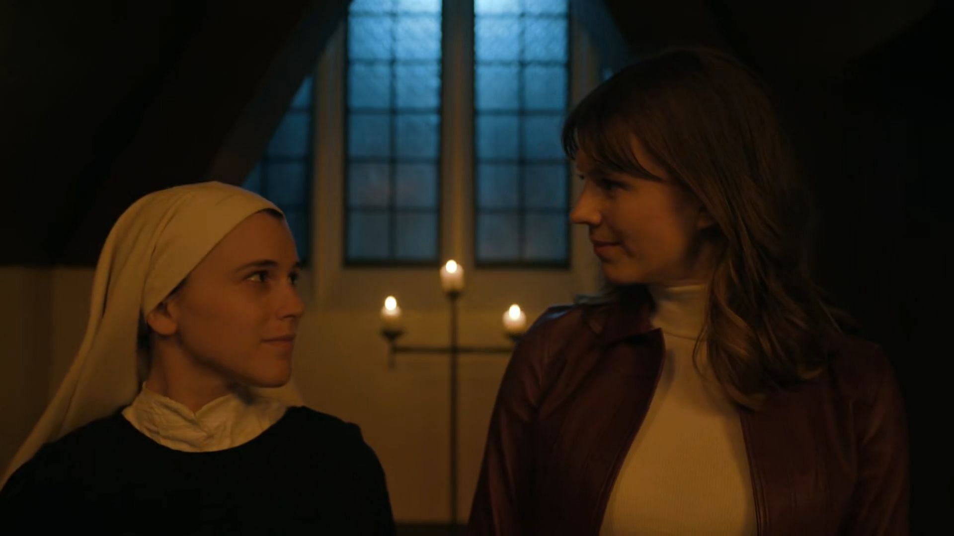 A young nun and Kristen looking at each other while Leland getting confined in a cabinet, as seen in Evil season 4 episode 14 (Image via Paramount+)