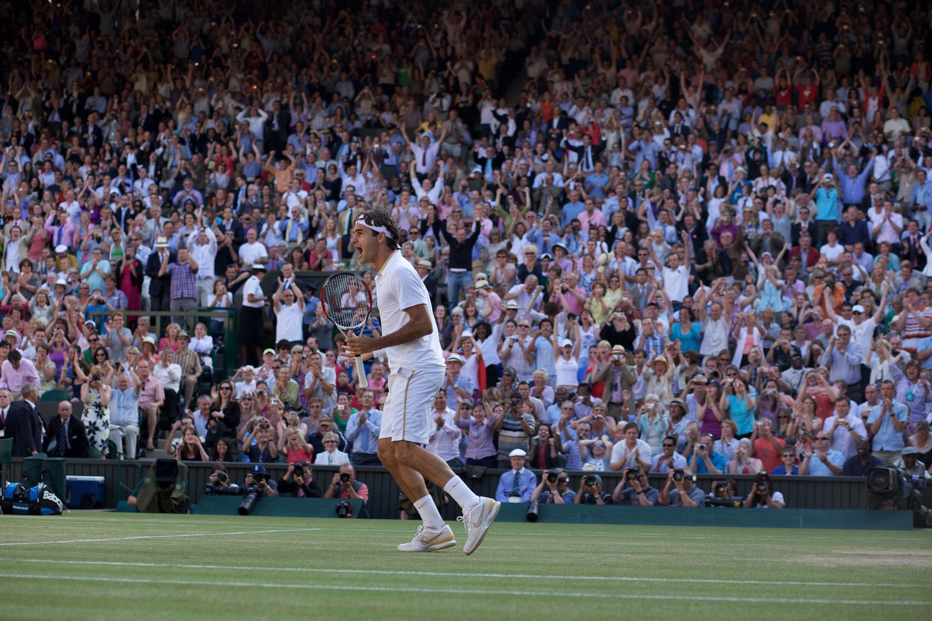 Roger Federer celebrates his five-set victory over Andy Roddick at the Wimbledon Championships 2009 (Photo by Tim Clayton/Corbis via Getty Images)