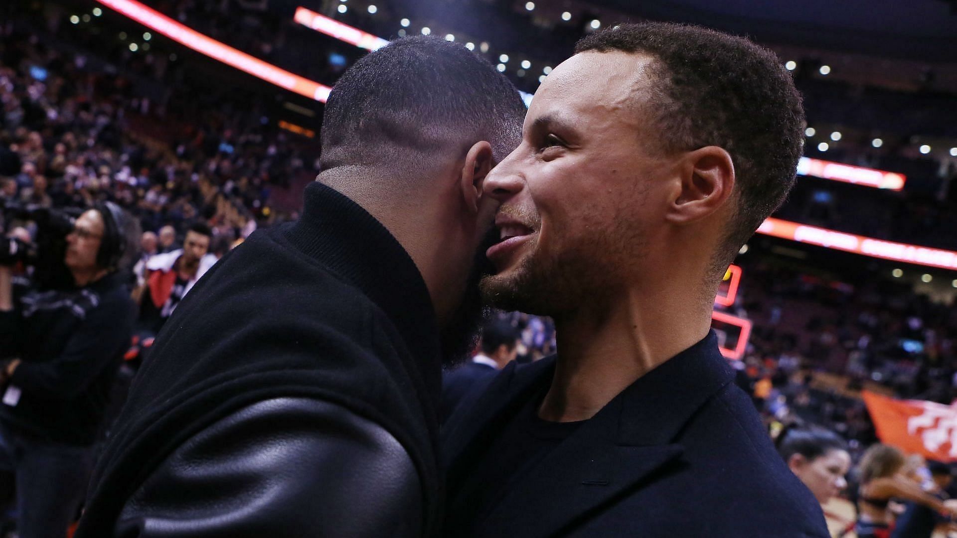 Steph Curry #30 of the Golden State Warriors speaks to singer Drake following an NBA game against the Toronto Raptors at Scotiabank Arena on November 29, 2018, in Toronto, Canada. (Photo by Vaughn Ridley/Getty Images)