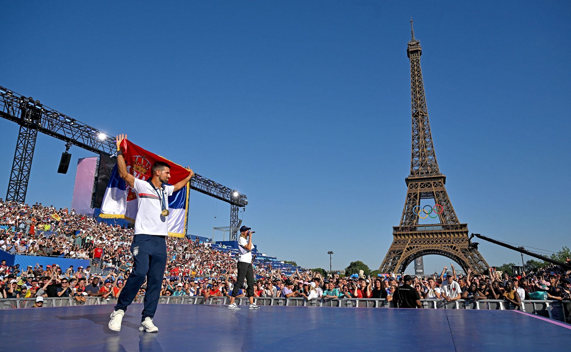 Novak Djokovic waves Serbia&#039;s flag after winning Olympic gold