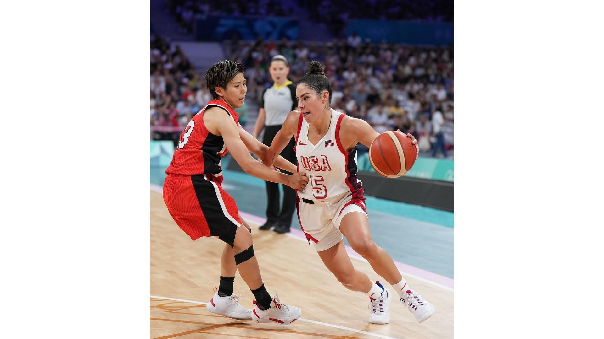 Plum drives past a player at the 2024 Paris Olympics. Image Credit: K. Plum&#039;s IG account