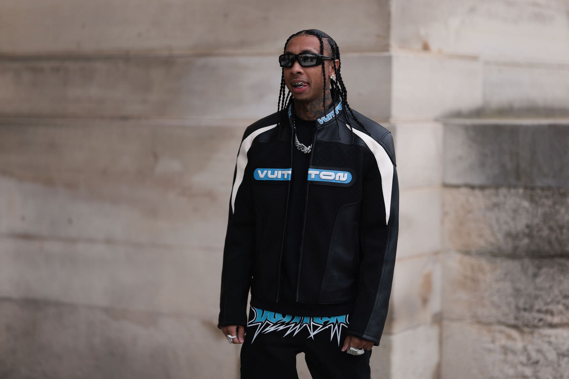 Tyga arrives in a full Louis Vuitton ensemble at the Louis Vuitton Show during Paris Fashion Week on January 19, 2023. (Photo by Getty/Jeremy Moeller)