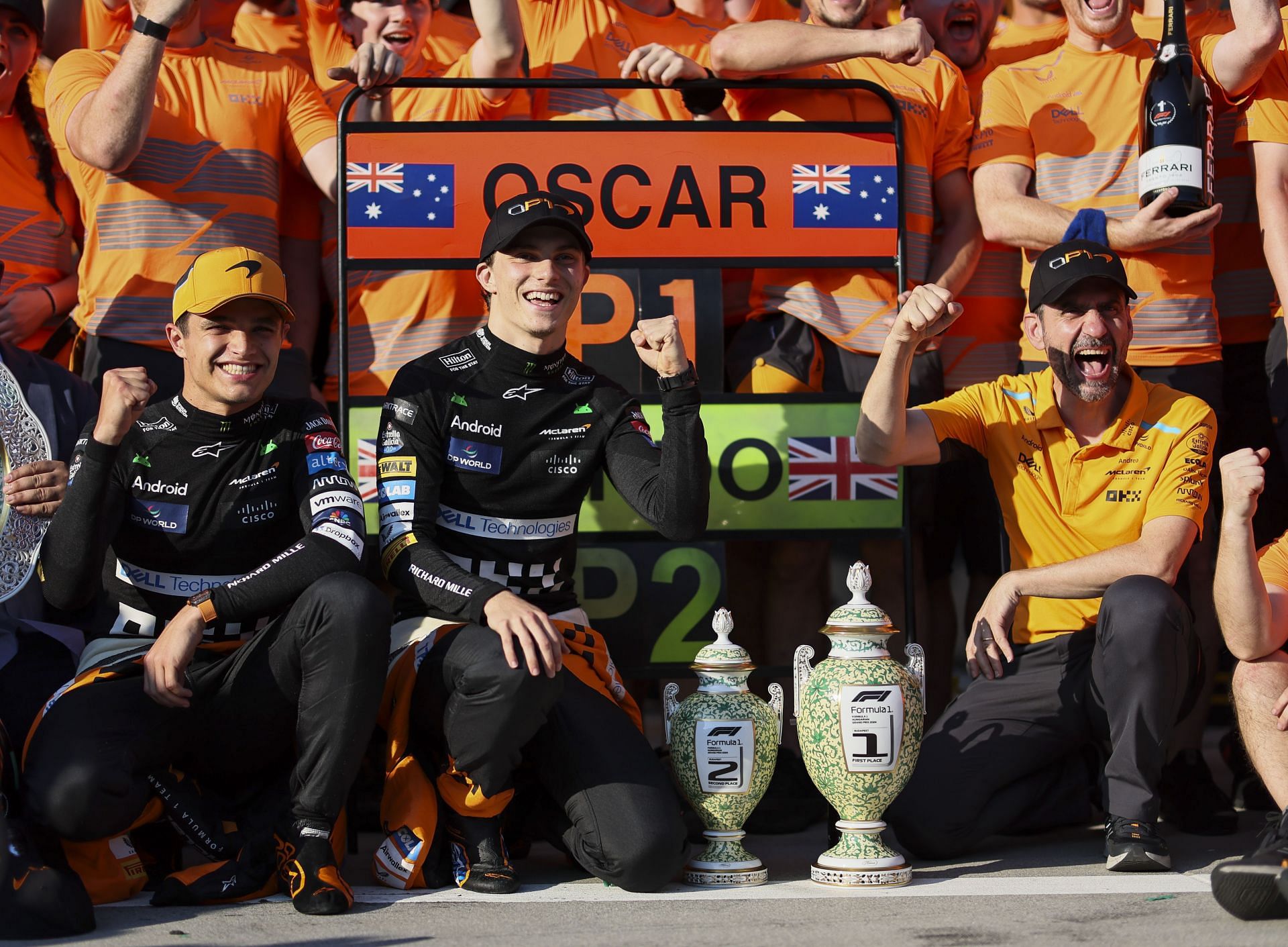 Lando Norris [L, in yellow cap] and Oscar Piastri [C] of McLaren F1 Team (Source: Getty Images)