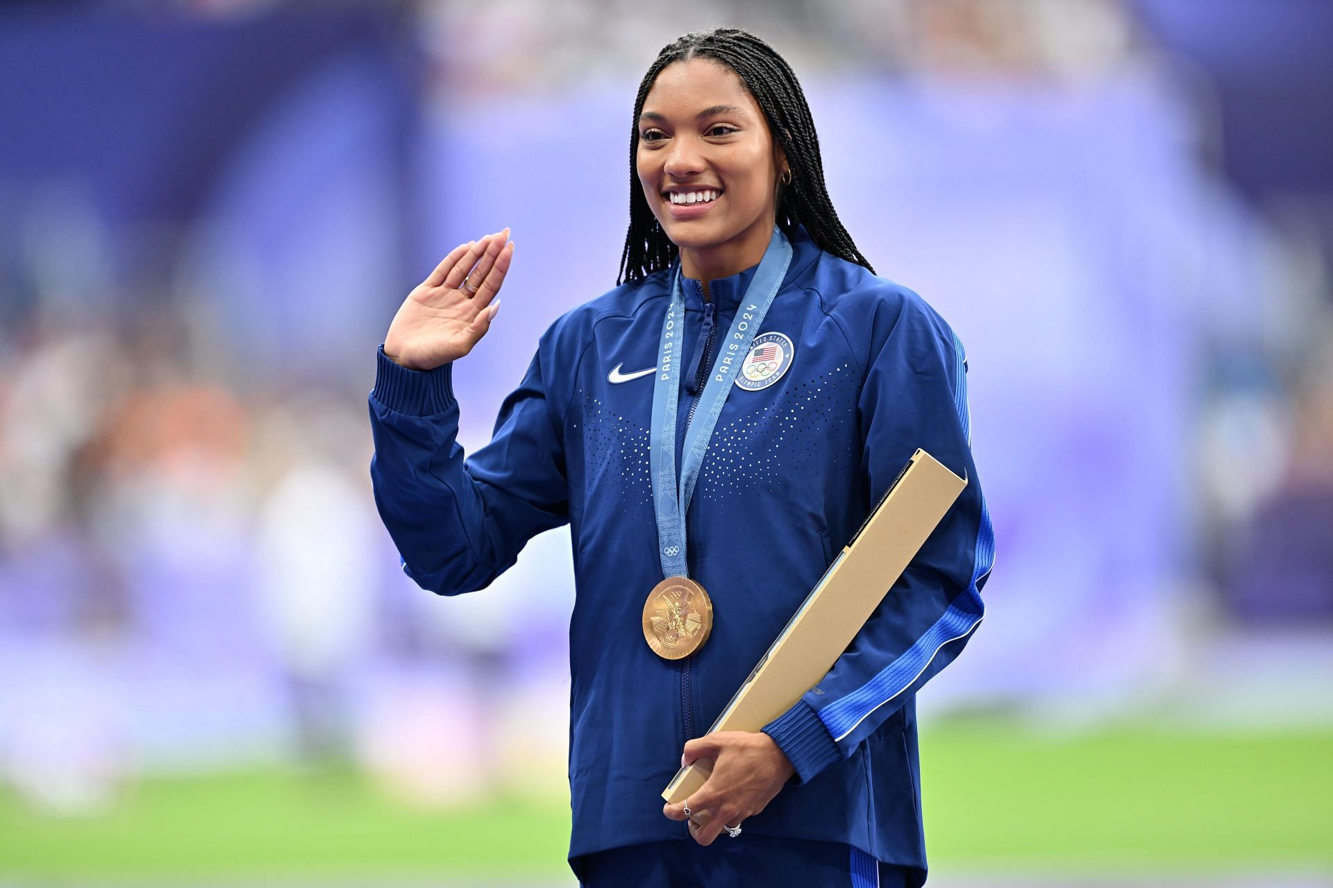 Tara Davis-Woodhall with her gold medal at the 2024 Summer Olympics in Paris (Image via: Getty Images)