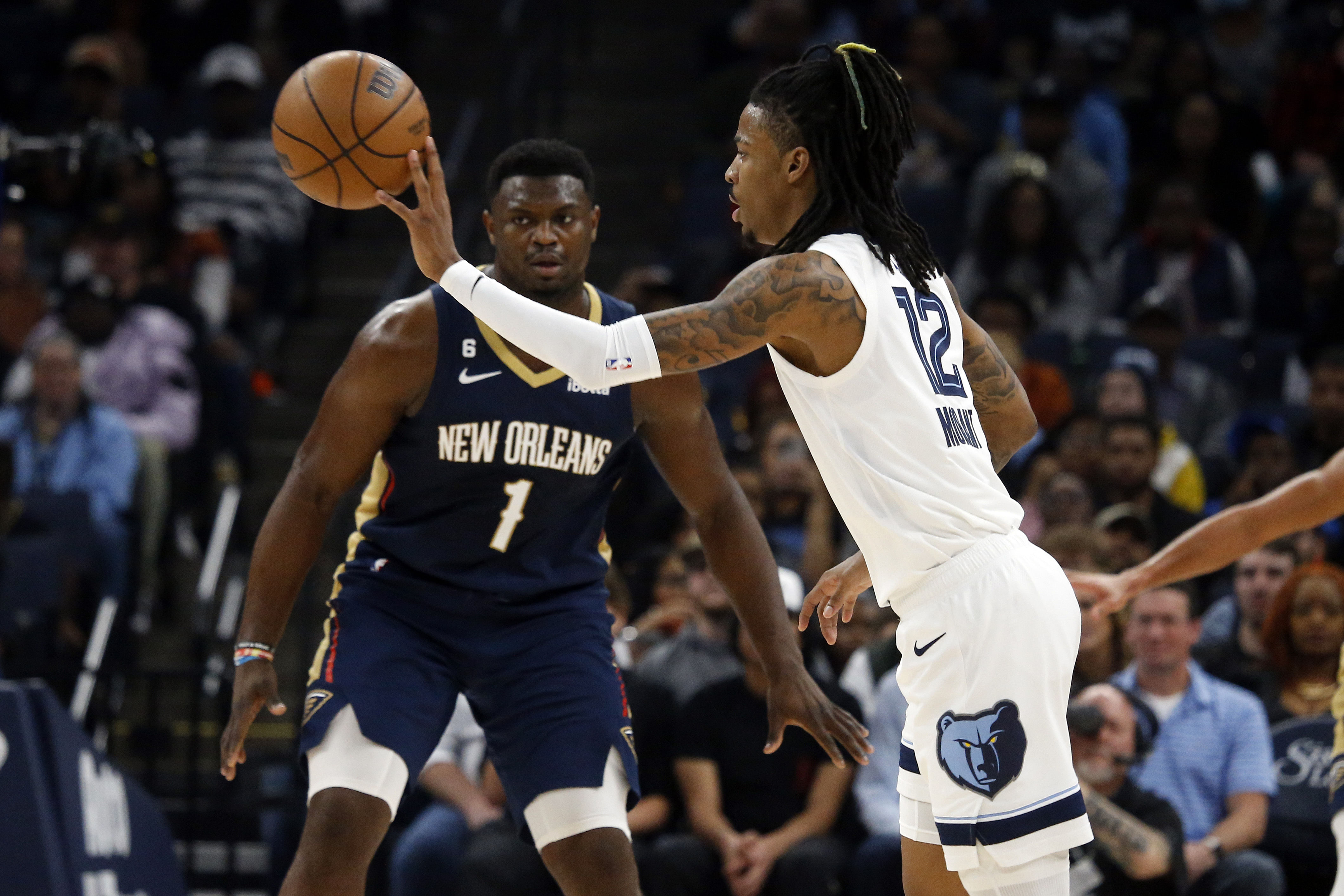 Memphis Grizzlies guard Ja Morant passes the ball against New Orleans Pelicans forward Zion Williamson during the first quarter at FedExForum (Photo Credits: IMAGN)