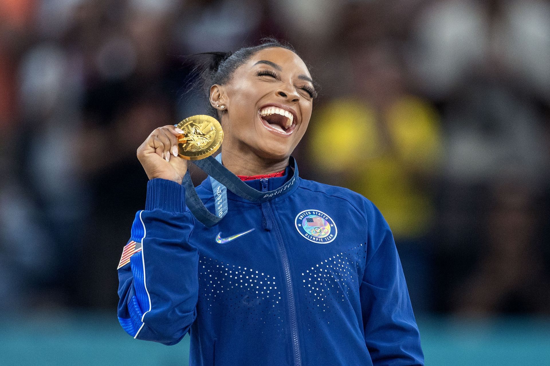 Simone Biles of the United States celebrates with her gold medal after her victory on the vault apparatus during the 2024 Summer Olympic Games in Paris, France. (Photo via Getty Images)