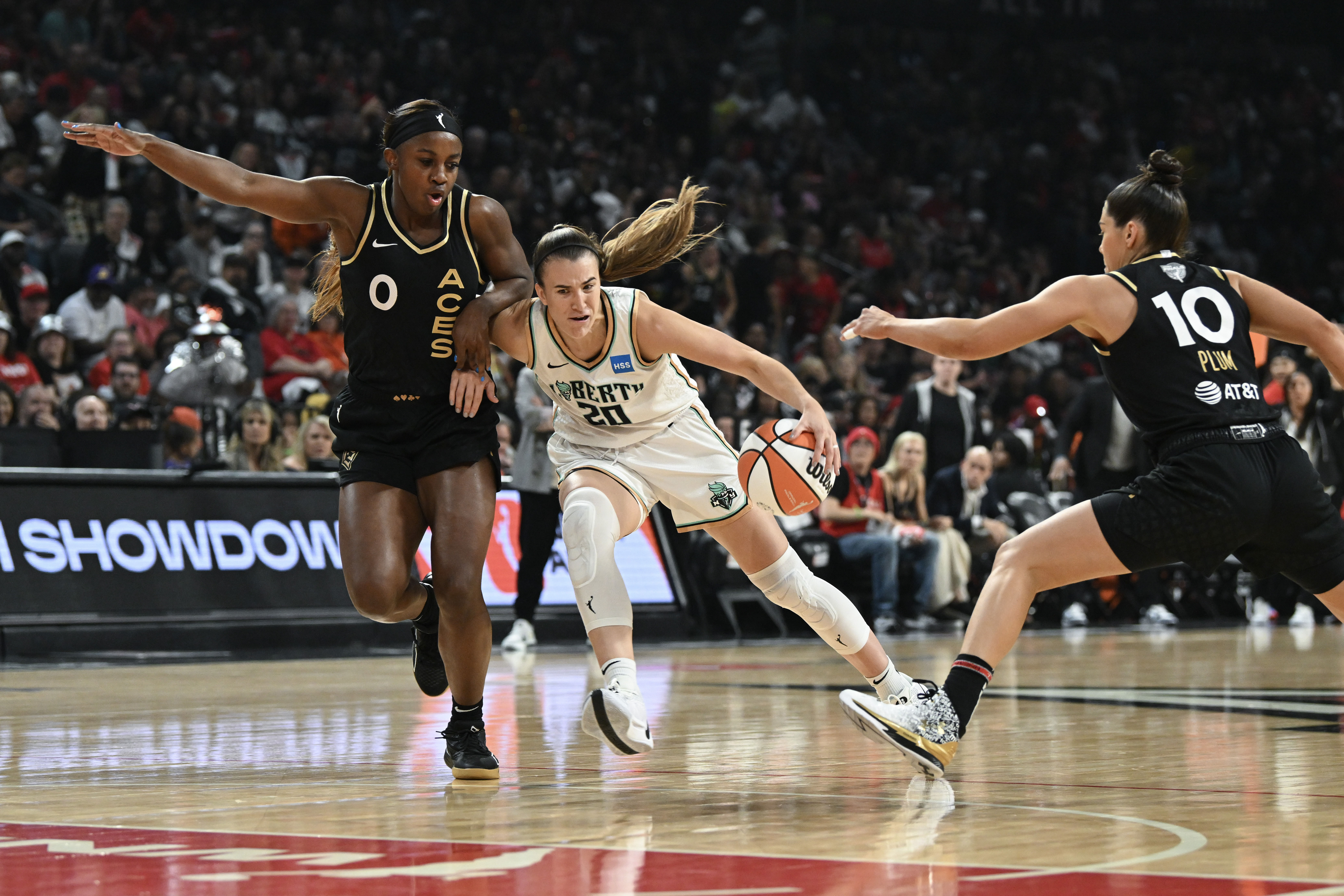 New York Liberty guard Sabrina Ionescu drives past Las Vegas Aces guard Jackie Young and Kelsey Plum during he 2023 WNBA Finals at Michelob Ultra Arena. Photo Credit: Imagn