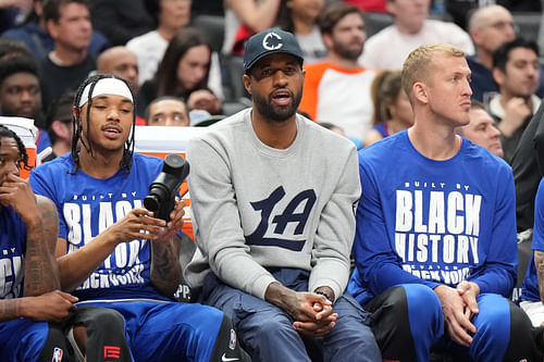 Forward Paul George watches from the bench against the Sacramento Kings at Crypto.com Arena. Photo Credit: Imagn