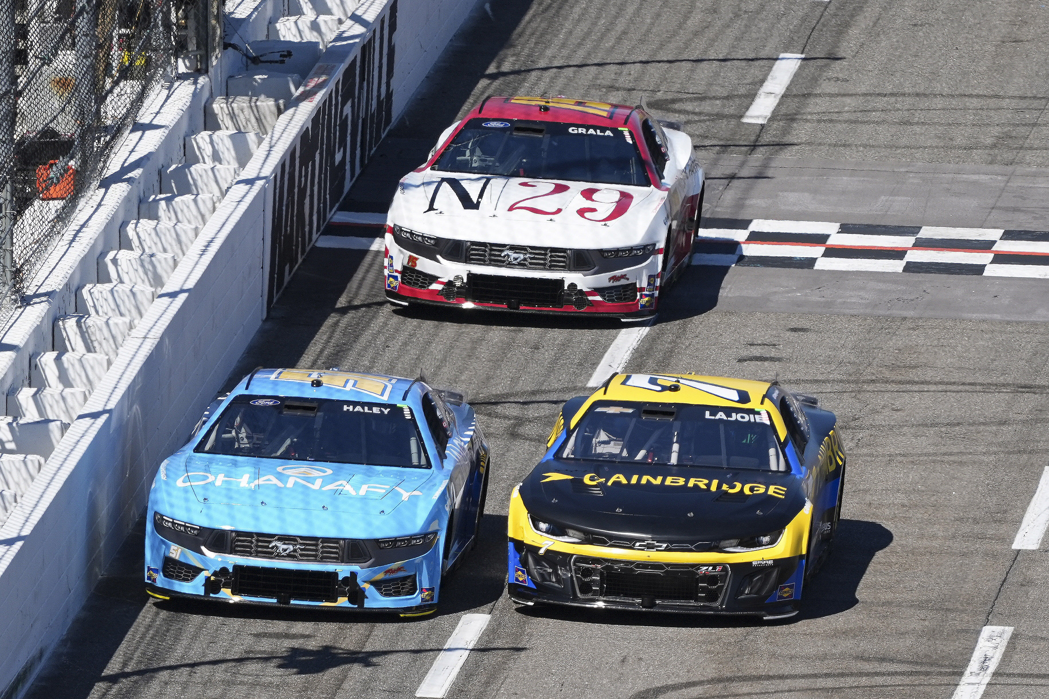 Corey LaJoie (7) and driver Justin Haley (51) battle down the front stretch during the Cook Out 400 at Martinsville Speedway (Image via Imagn)