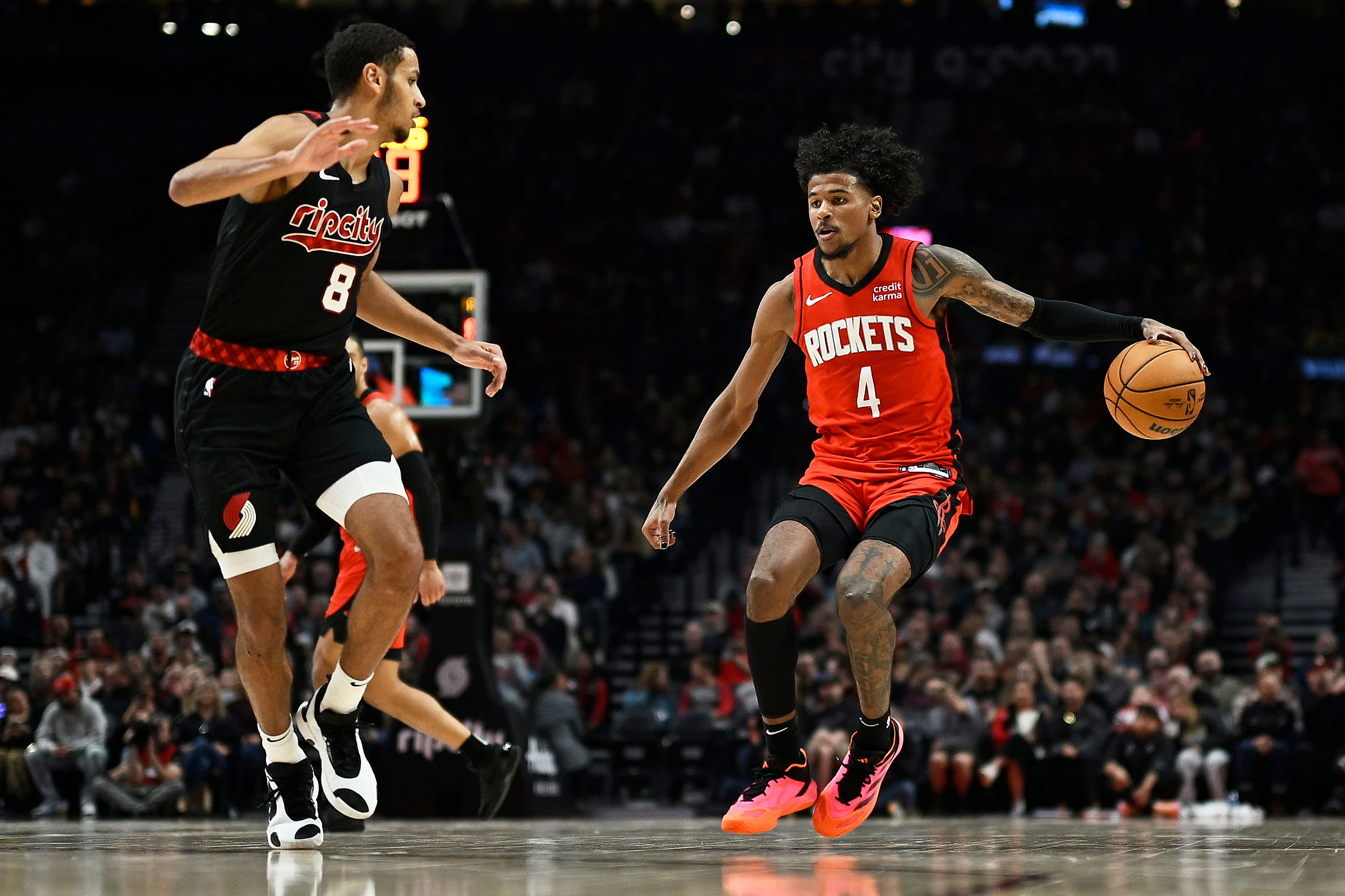 Houston Rockets guard Jalen Green dribbles the basketball against Portland Trail Blazers forward Kris Murray at Moda Center. Photo Credit: Imagn