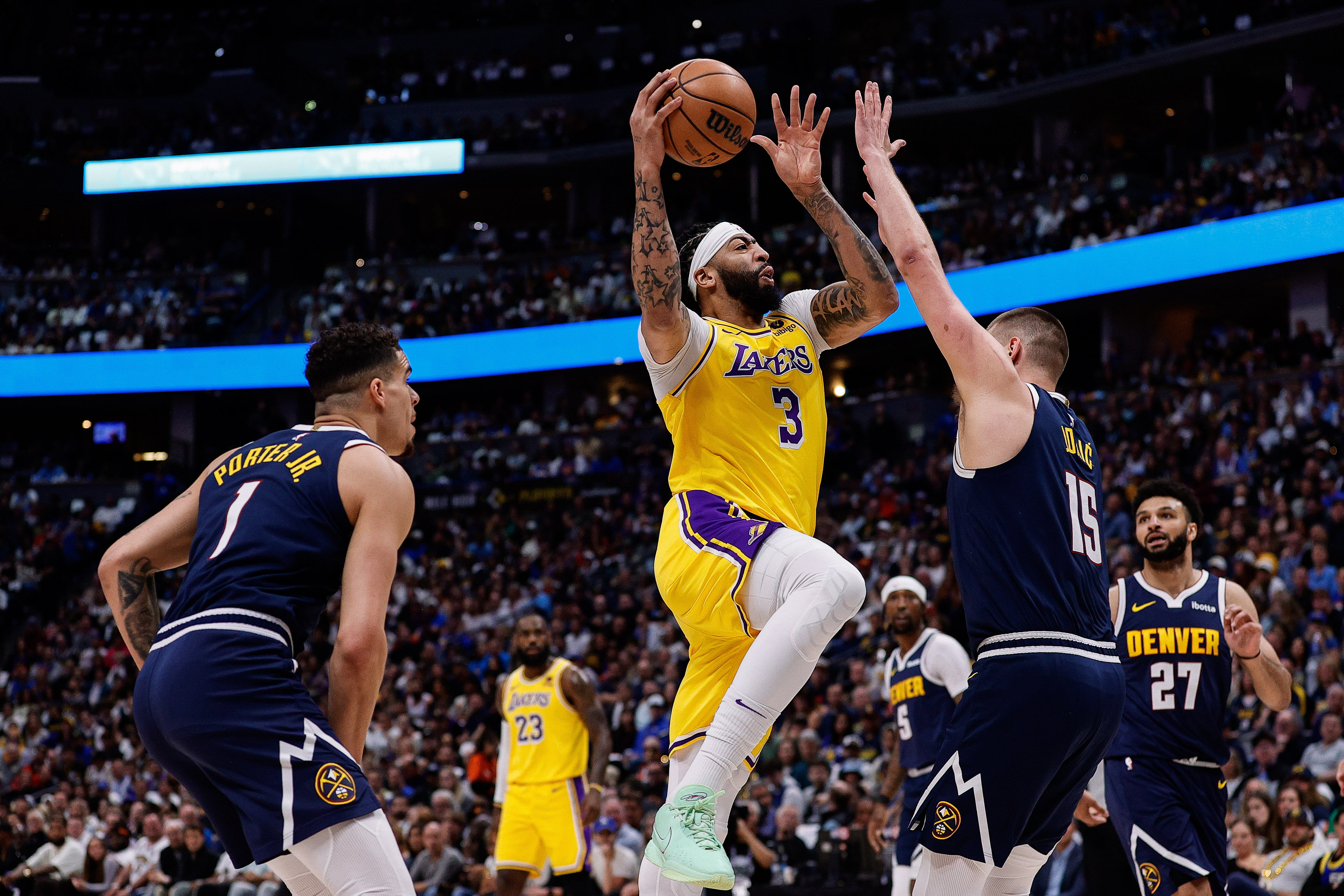 LA Lakers forward shooting over Denver Nuggets center Nikola Jokic - Source: Imagn