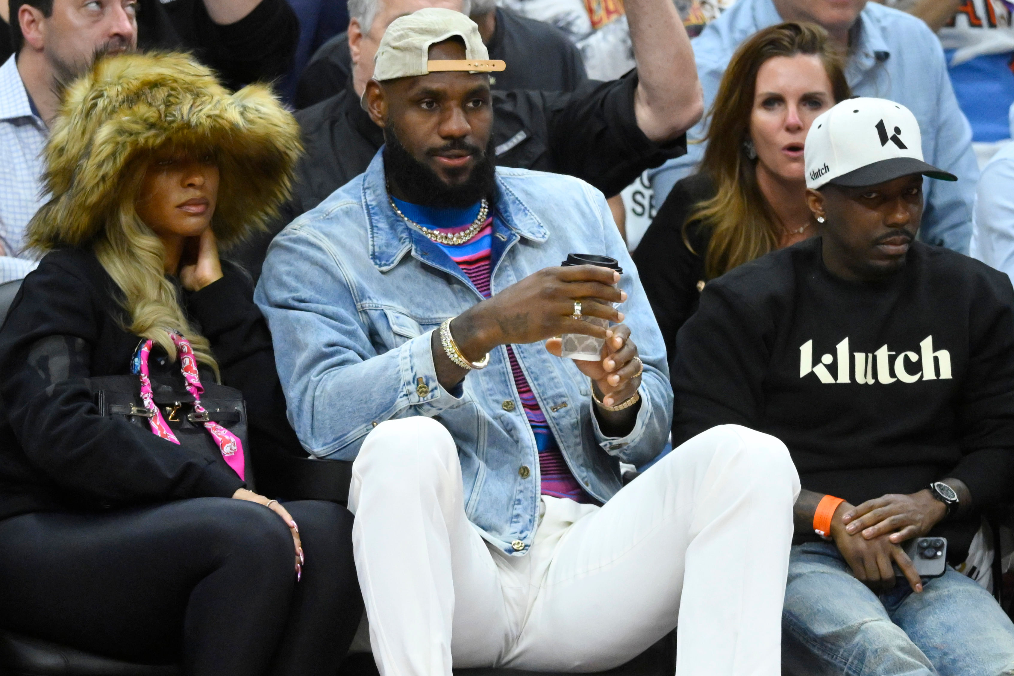 Savannah James, LeBron James and Rich Paul sit in the front at Rocket Mortgage FieldHouse. Photo Credit: Imagn