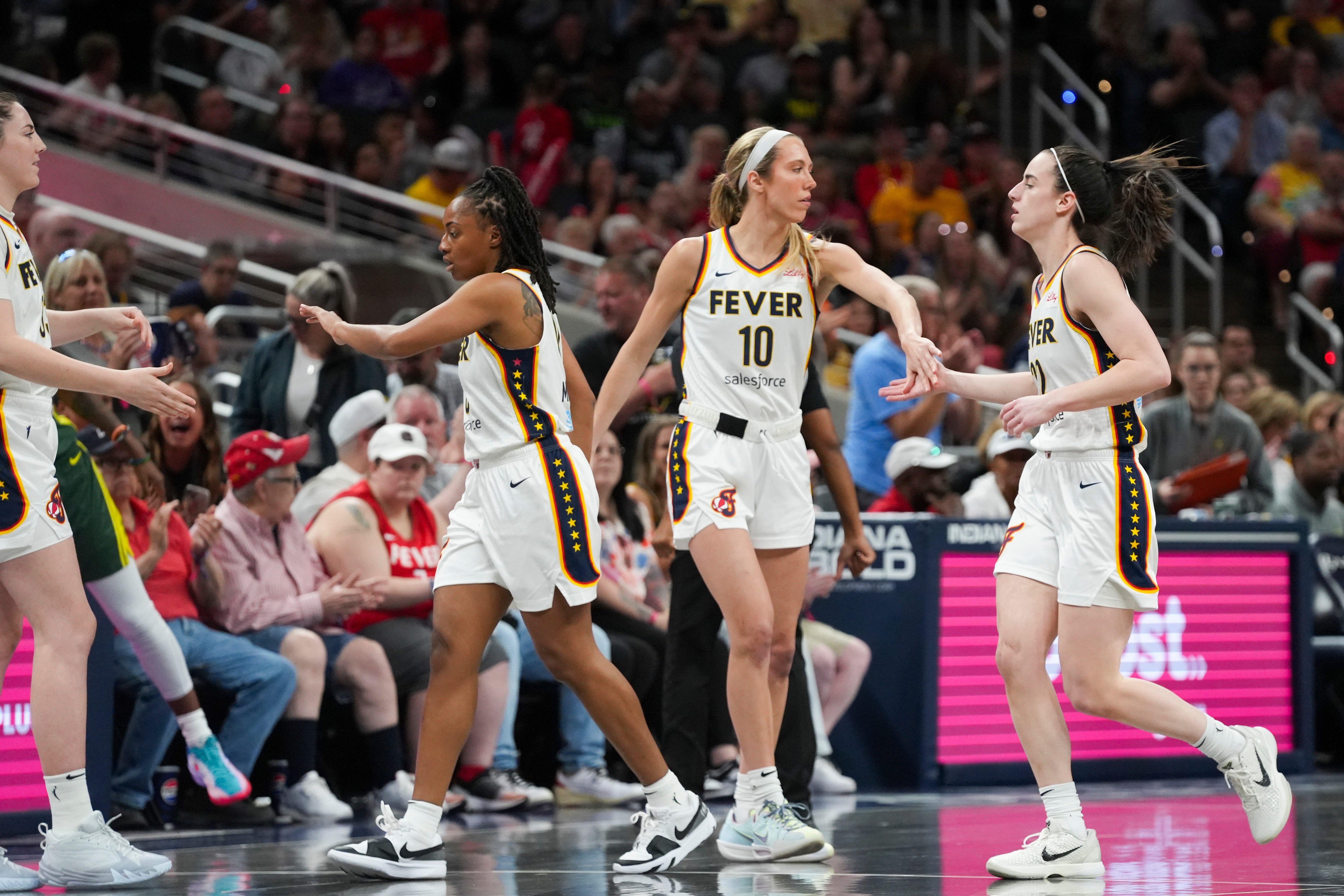 Indiana Fever guard Lexie Hull low fives Indiana Fever guard Caitlin Clark during the WNBA game at Gainbridge Fieldhouse in Indianapolis. Photo Credit: Imagn