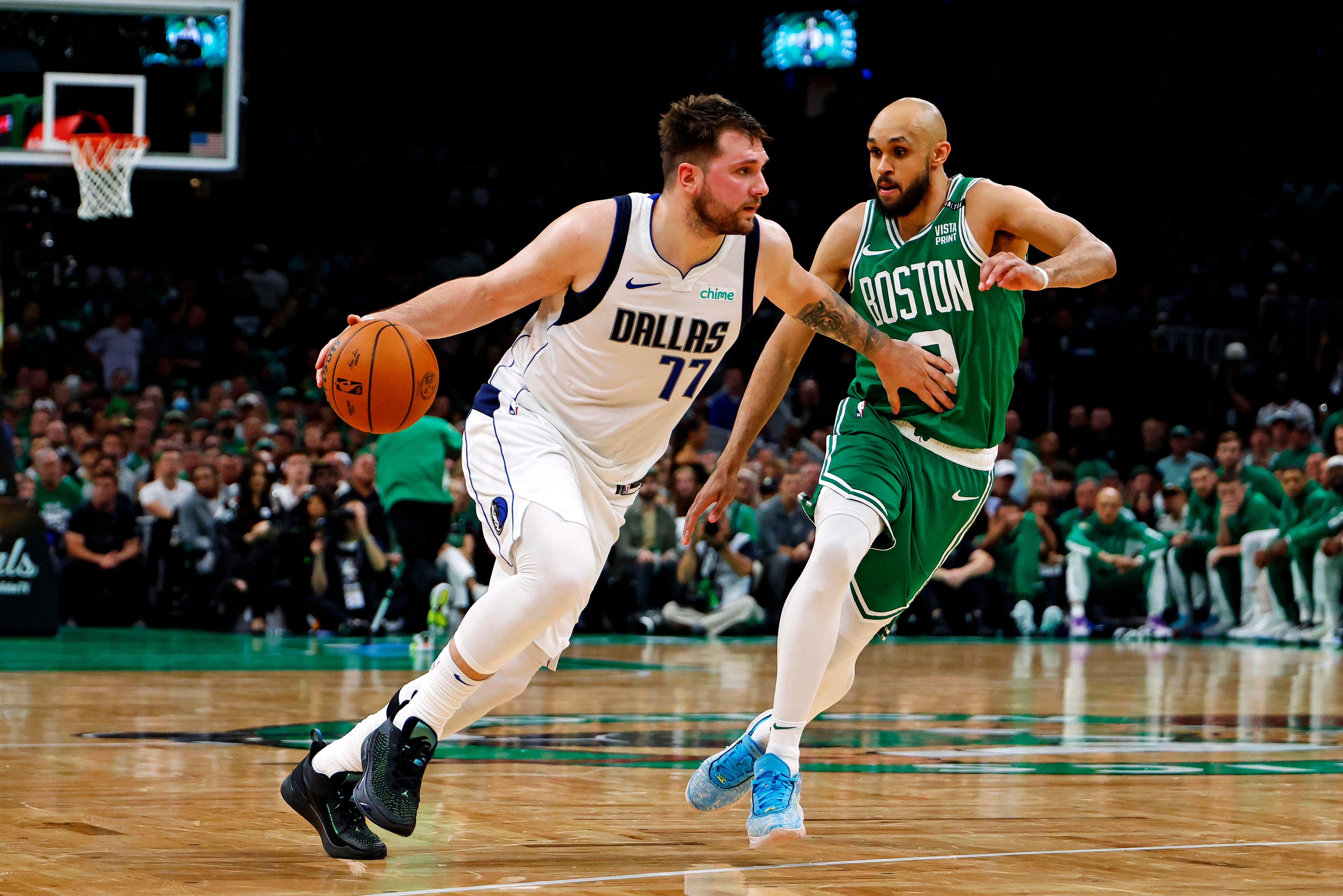 Dallas Mavericks guard Luka Doncic drives to the basket against Derrick White at the TD Garden. Photo Credit: Imagn