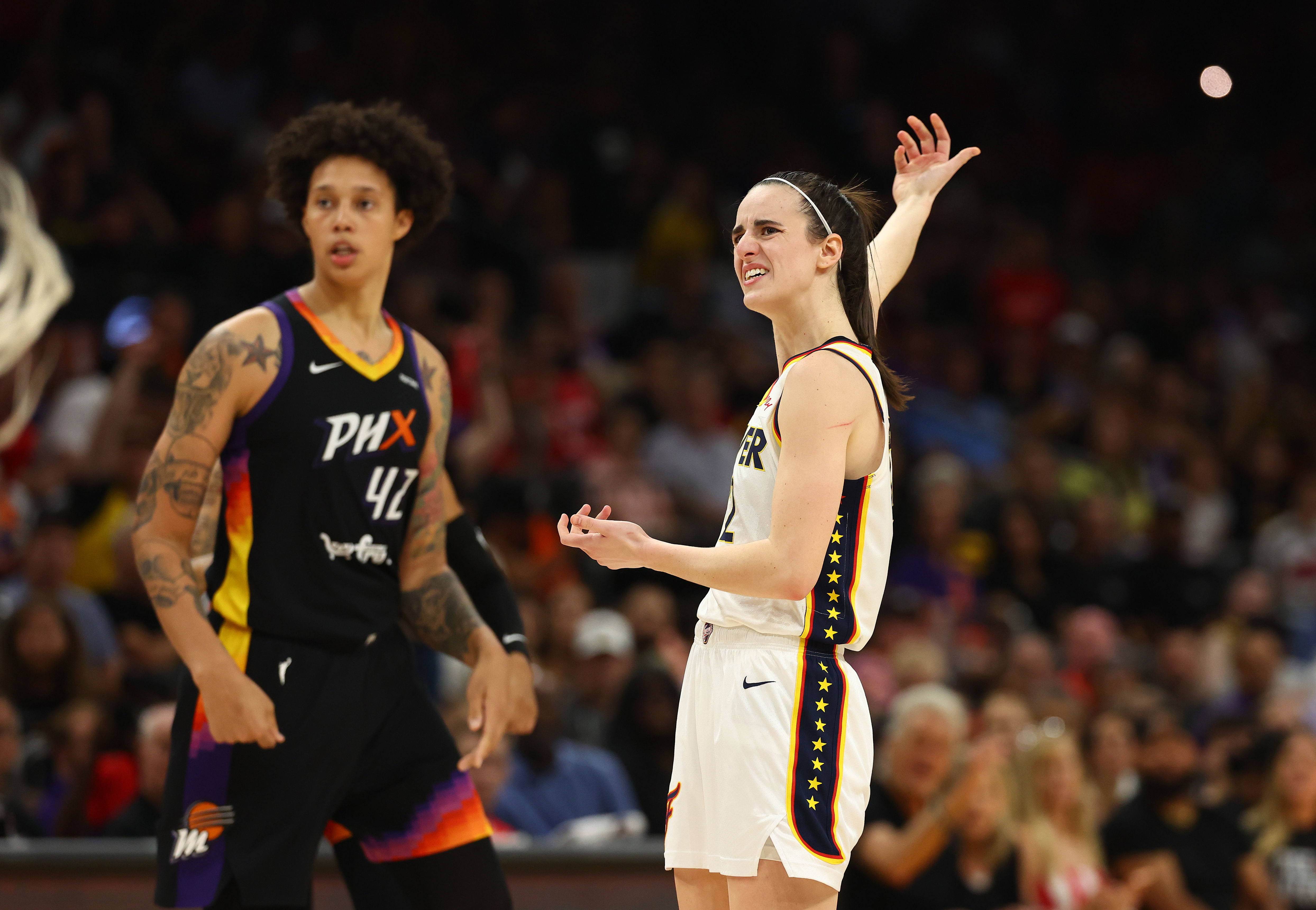 Indiana Fever guard Caitlin Clark against Phoenix Mercury center Brittney Griner during a WNBA game at Footprint Center. Photo Credit: Imagn