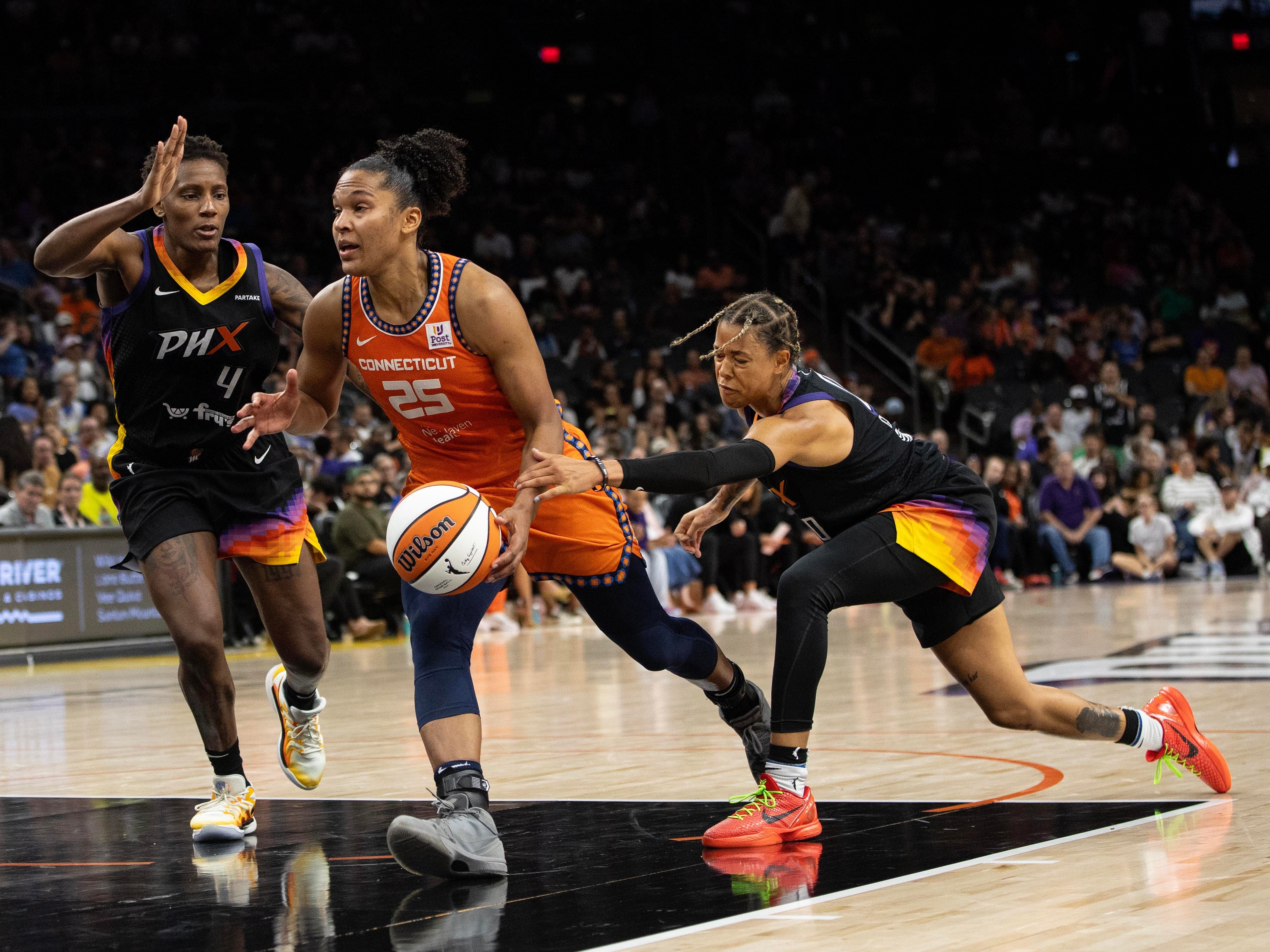 Phoenix Mercury guard Natasha Cloud fouls Connecticut Sun forward Alyssa Thomas at Footprint Center in Phoenix. Photo Credit: Imagn