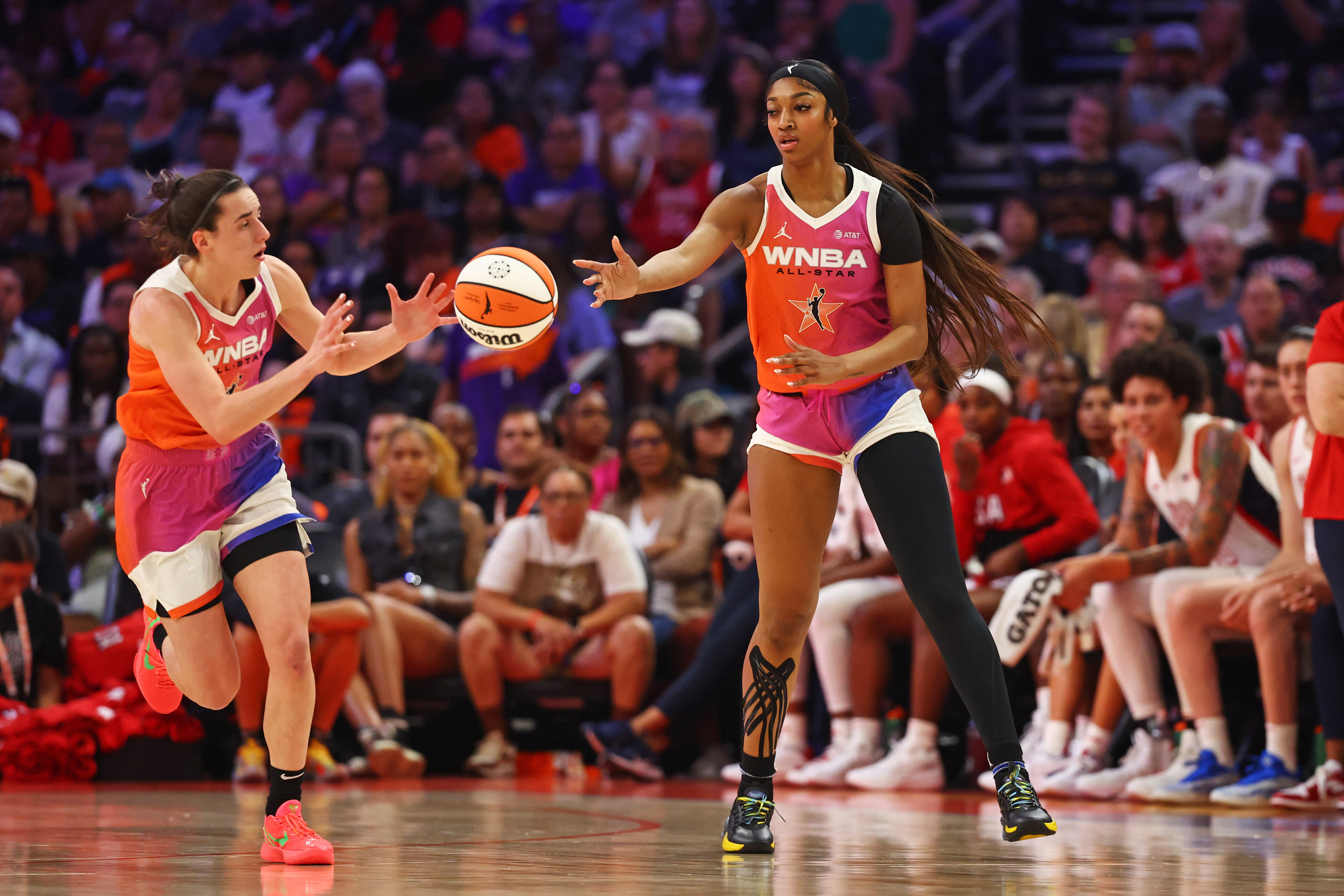 Team WNBA forward Angel Reese passes the ball to guard Caitlin Clark at Footprint Center. Photo Credit: Mark J. Rebilas-Imagn Images