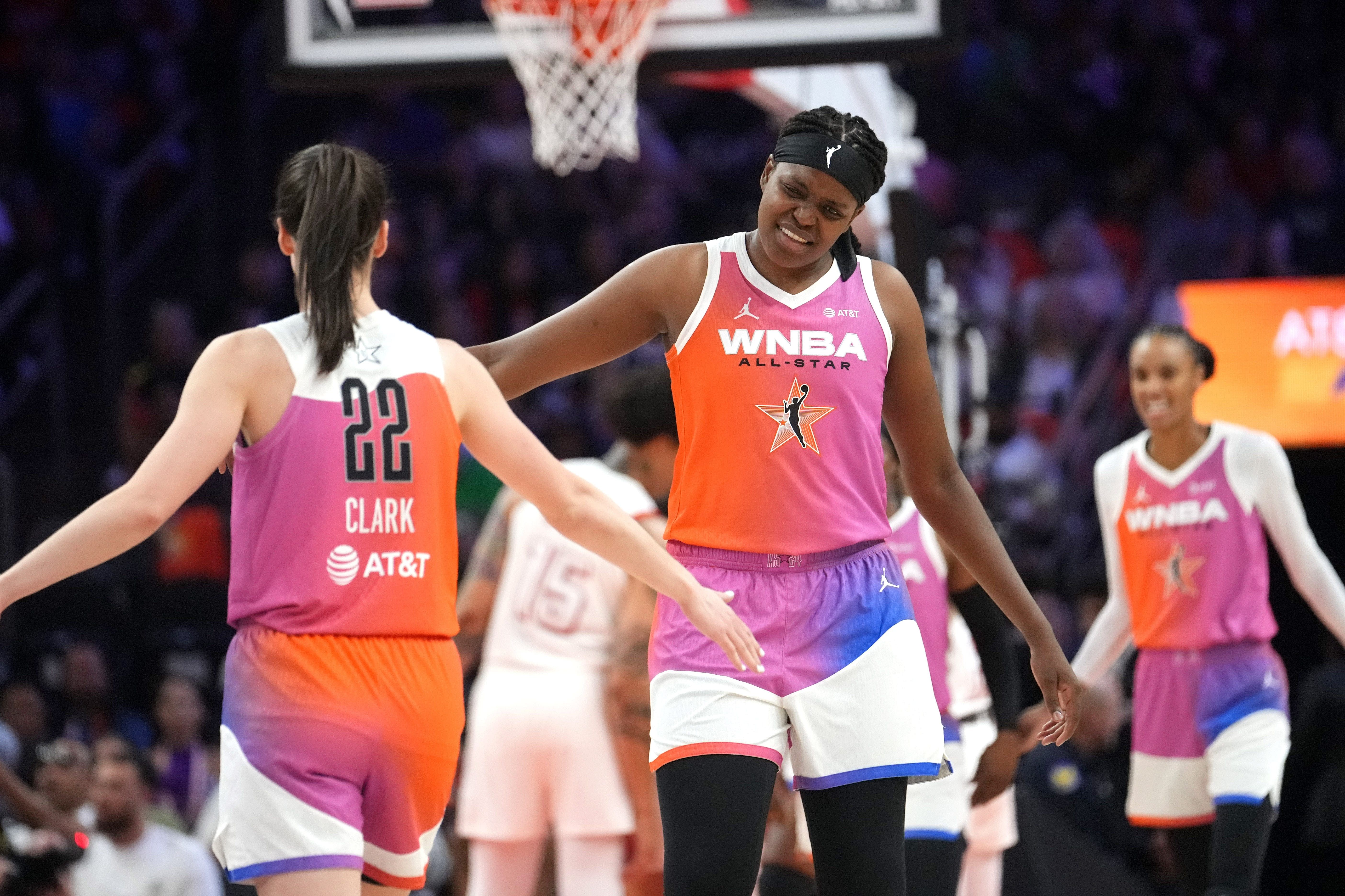 Team WNBA center Jonquel Jones high-fives Caitline Clark after her assist against Team USA during the WNBA All-Star Game at Footprint Center in Phoenix. Photo Credit: Imagn