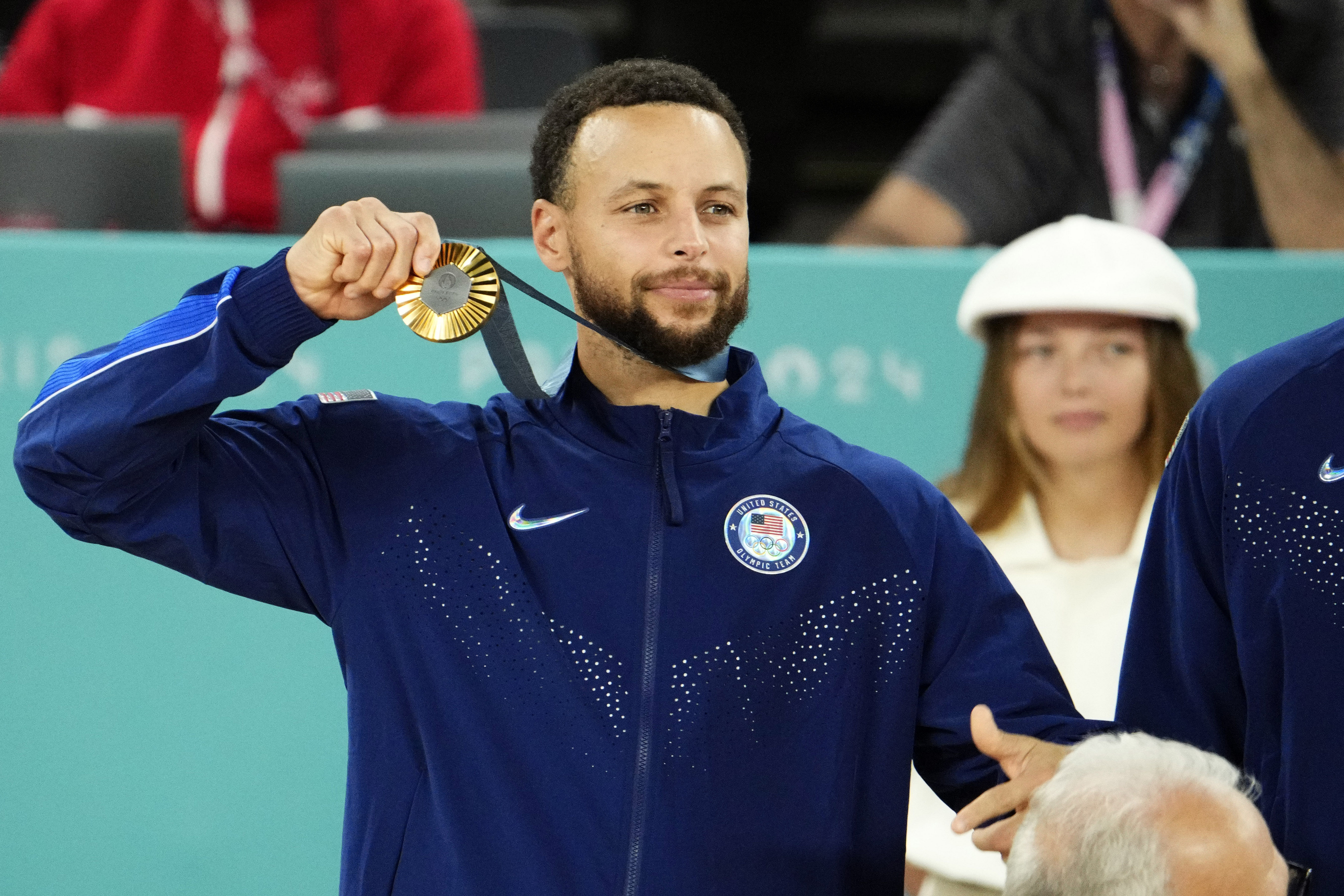 Stephen Curry celebrates with the gold medal after defeating France at the Paris 2024 Olympic Summer Games. Photo Credit: Imagn