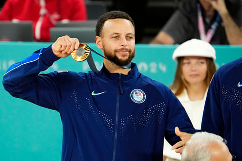 Stephen Curry celebrates with the gold medal after defeating France at the Paris 2024 Olympic Summer Games. Photo Credit: Imagn