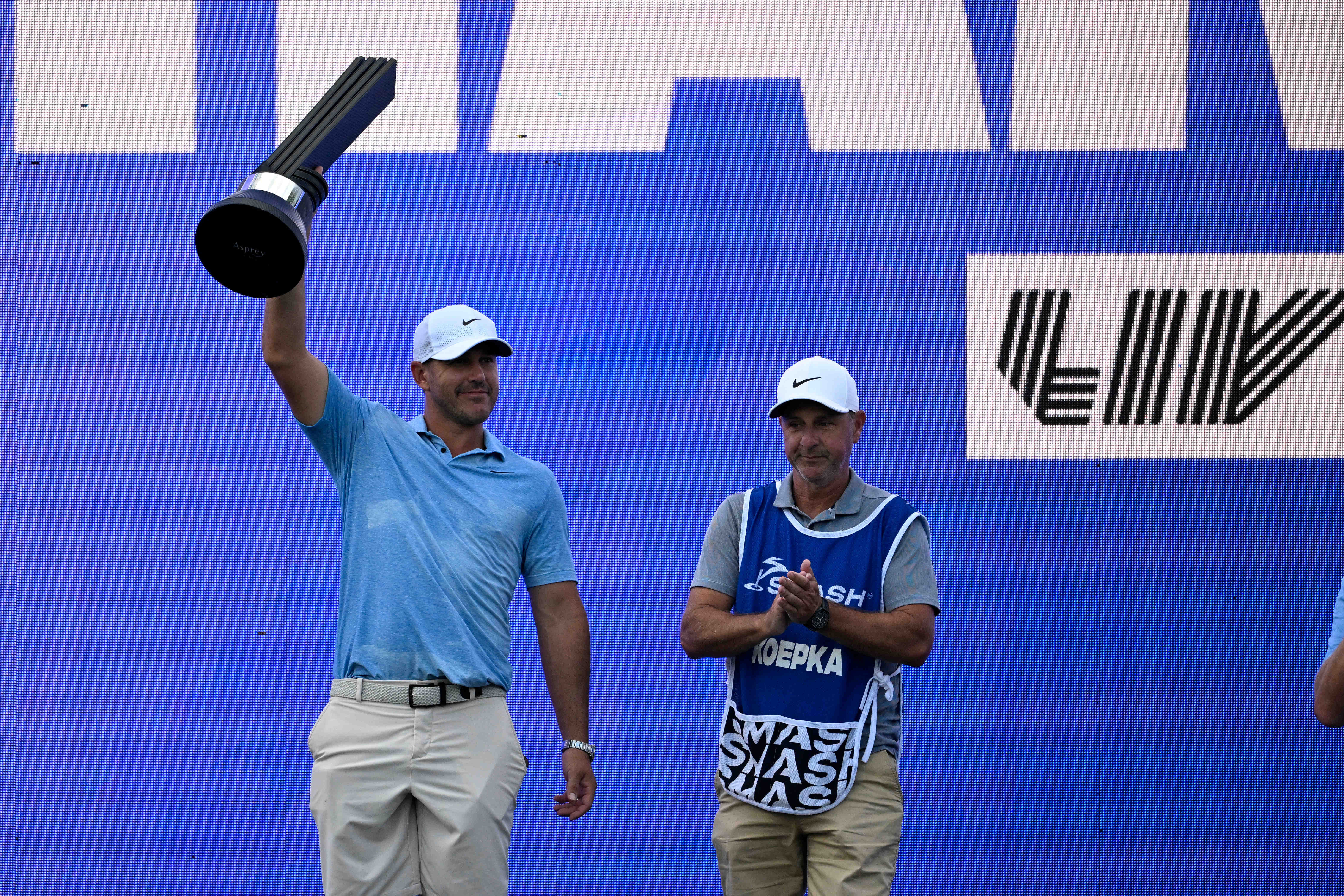 Brooks Koepka poses with a trophy after winning the LIV Golf Greenbrier (Image Source: Imagn)