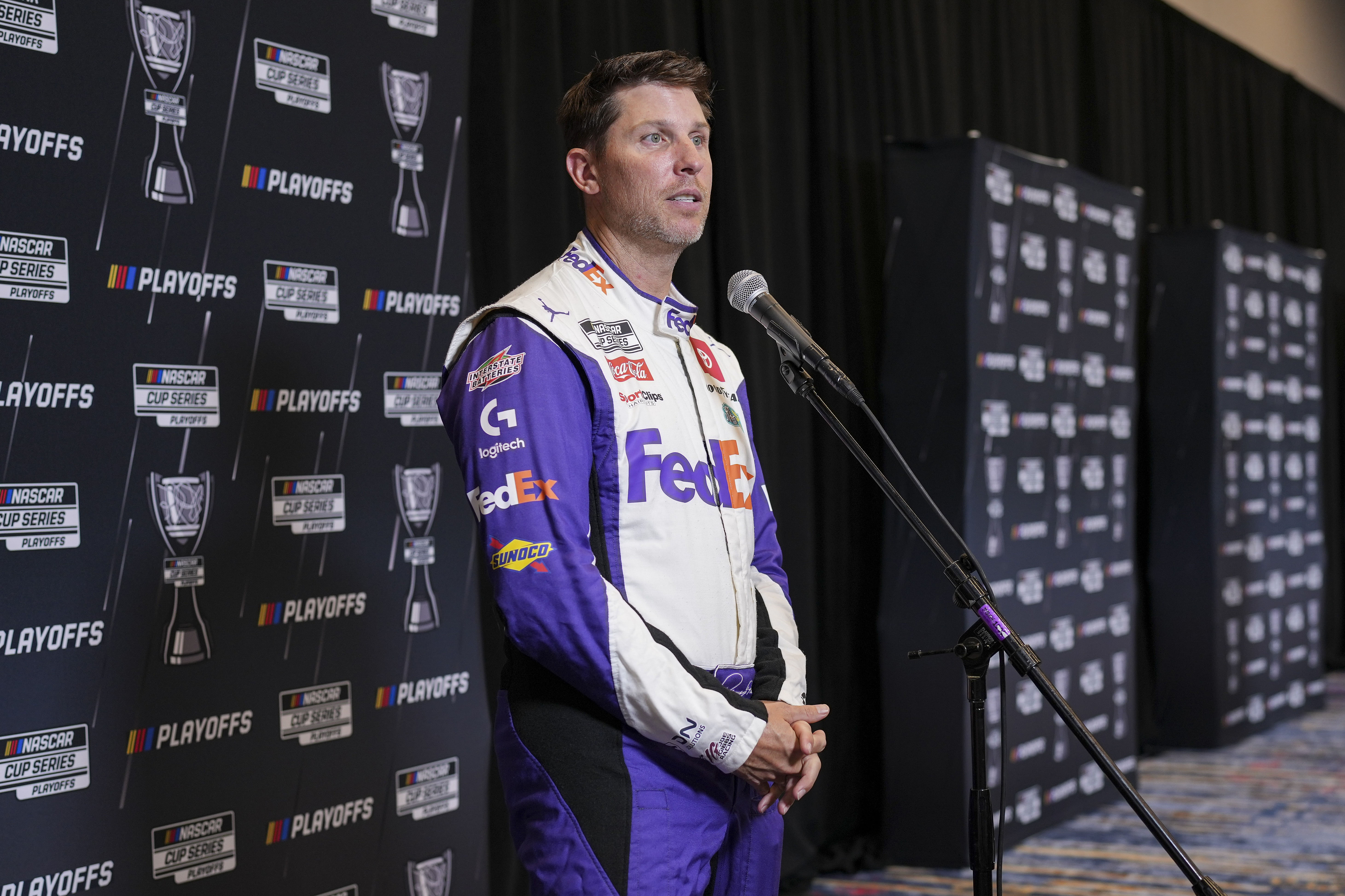 Denny Hamlin speaks to media members during the NASCAR Playoffs Media Day | Imagn