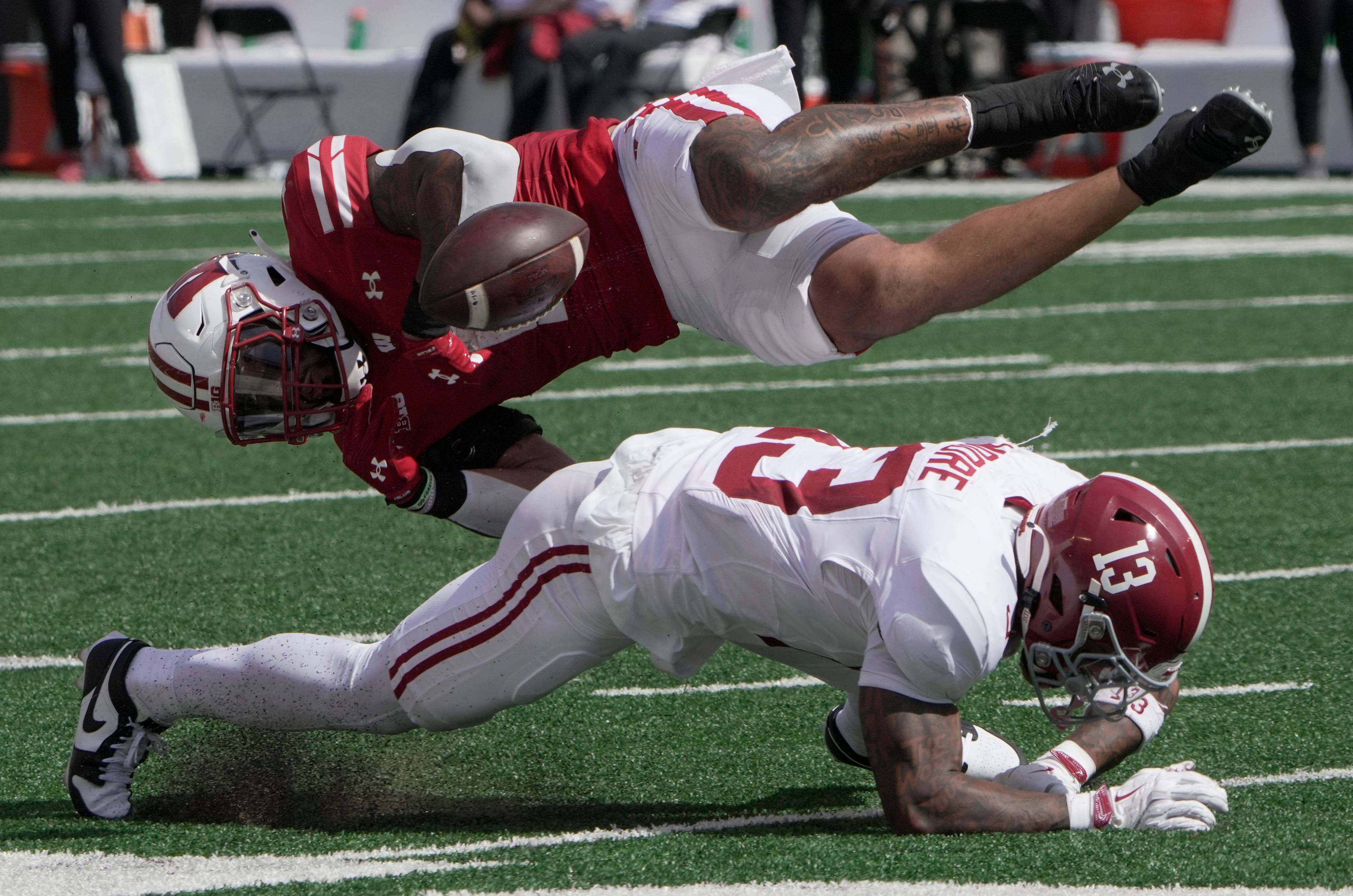 Wisconsin running back Chez Mellusi (1) fumbles the ball after being hit by Alabama defensive back Malachi Moore - Source: Imagn