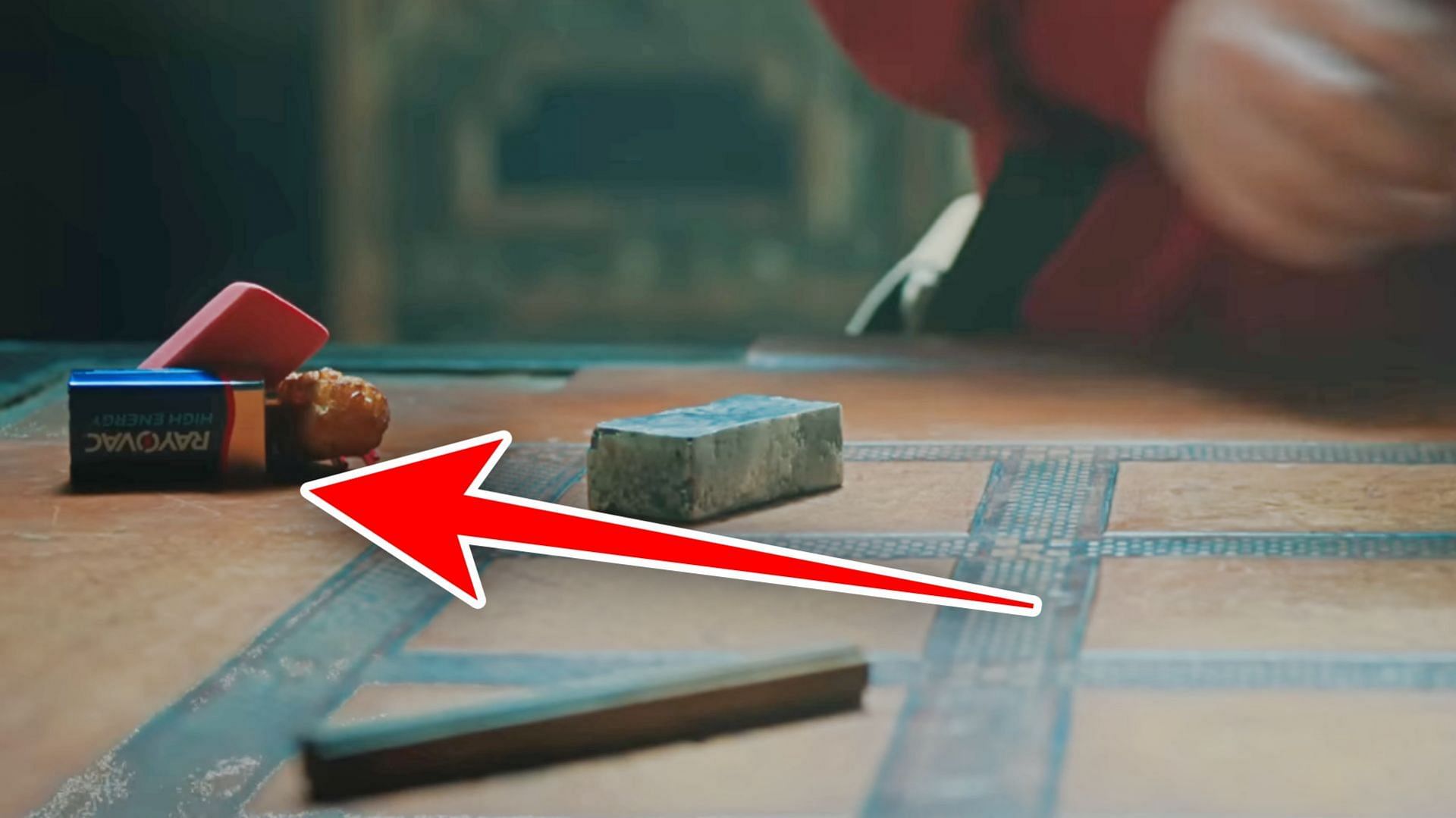 A real-life battery was placed on the crafting table in one of the shots (Image via YouTube/Warner Bros)