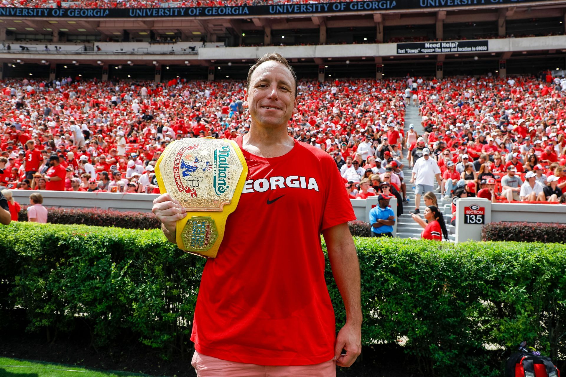 Chestnut showcasing a title at a Ball State v Georgia game (Photo by Brandon Sloter/Image Of Sport/Getty Images)