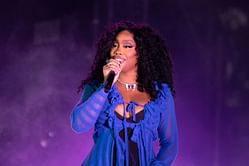 "That is NOT SZA" — Internet reacts to singer donning alien mask in Hot Ones promo