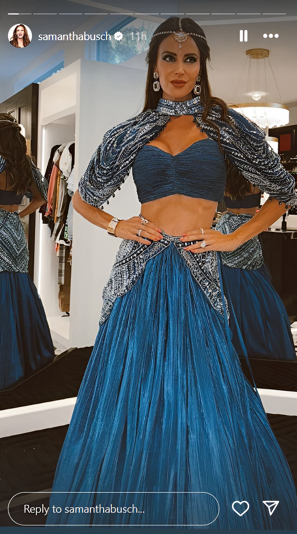 Samantha Busch posing in a blue-colored embroidered bridal lehenga (source: @samanthabusch on Instagram)