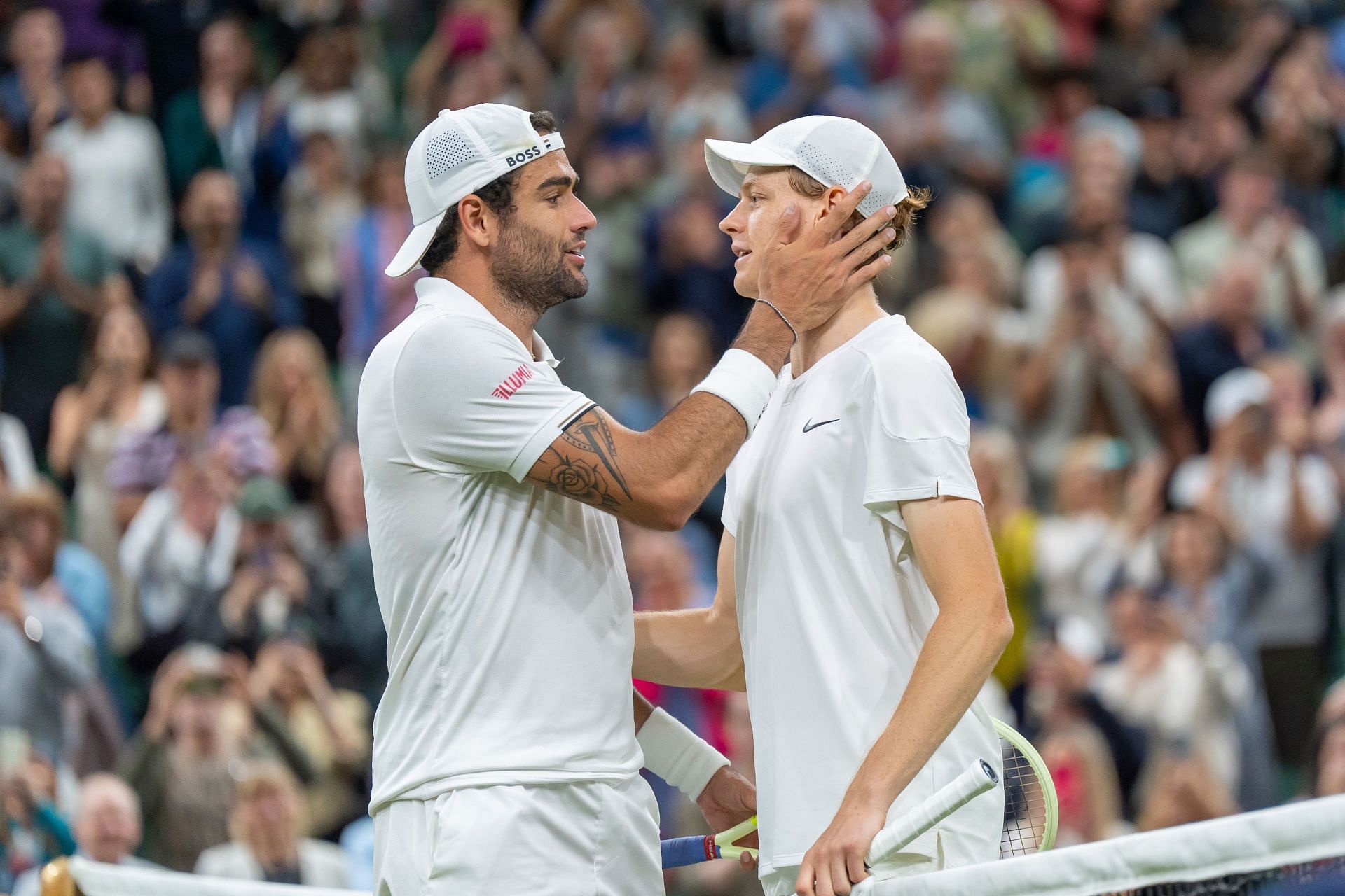 Matteo Berrettini and Jannik Sinner share a hug at Wimbledon 2024 - (Image: Getty)