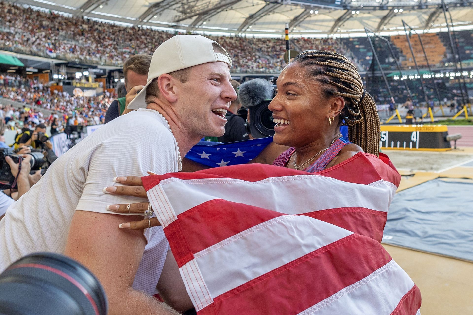 Tara Davis-Woodhall celebrates her silver medal win with her husband Hunter Woodhall after the Women&#039;s Long Jump Final during the 2023 World Athletics Championships in Budapest, Hungary. (Image source: Getty)