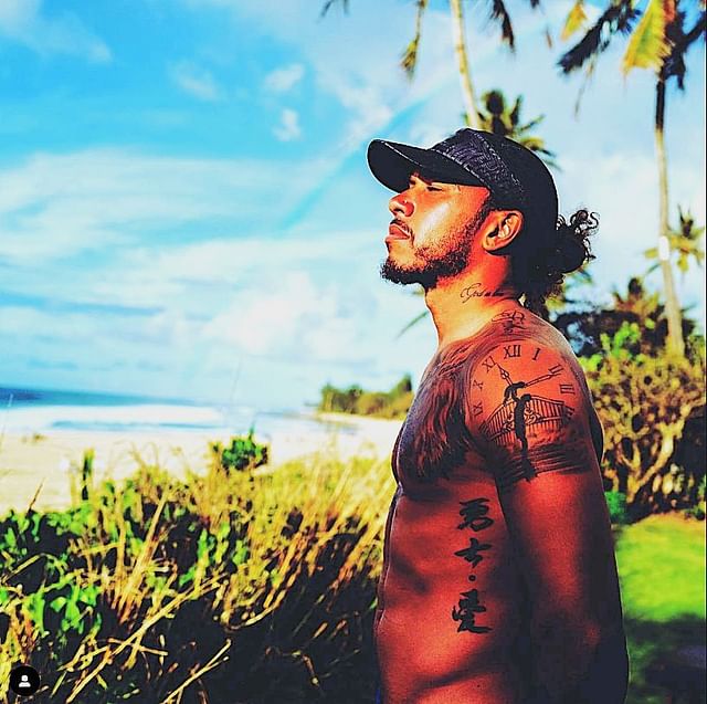 Lewis Hamilton enjoying the sunshine, showcasing the tattoo on his left shoulder (Source: @lewishamilton on Instagram)