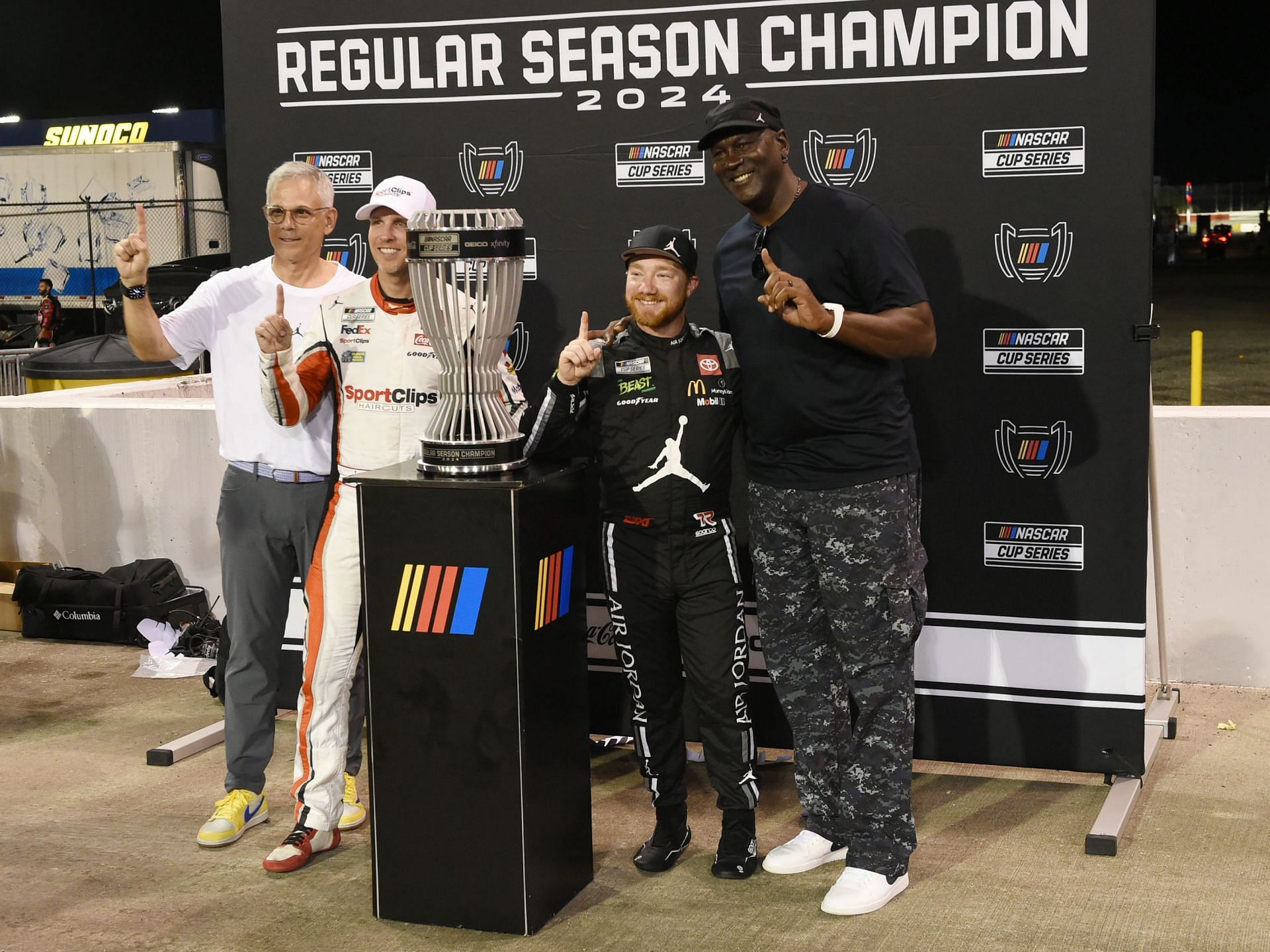 Tyler Reddick celebrates winning the NASCAR Regular Season Championship with team owners Denny Hamlin and Michael Jordan at Darlington Raceway (Source: Getty)